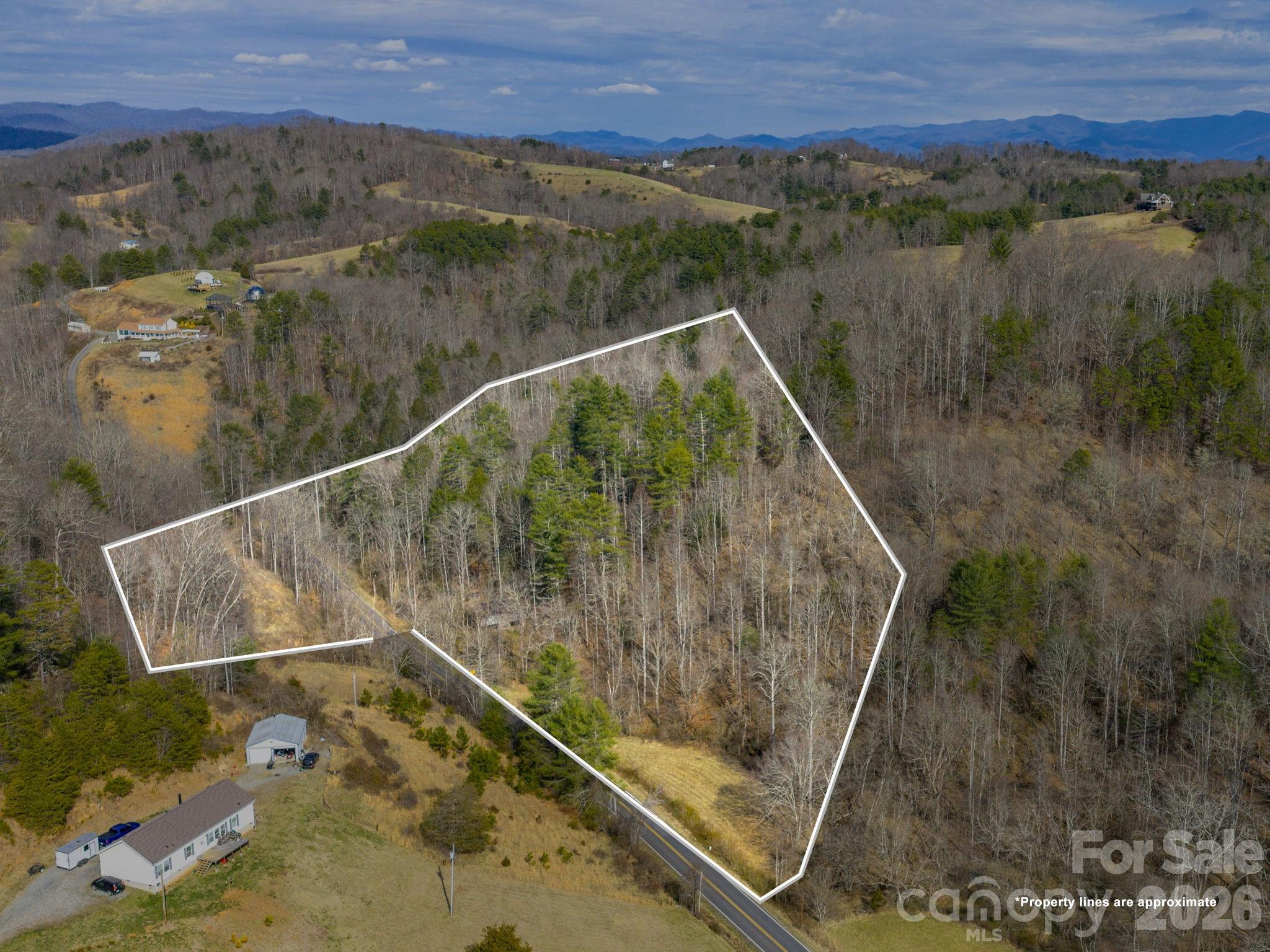 10 ± acres in Madison County NC less than 30 minutes to Asheville! Pasture, Forest, Stream & Antique Barn! Rare opportunity to own 10 ± acres on two adjacent parcels (PINs 9705-44-5714 & 9705-44-8932) with significant road frontage on Baileys Branch Road. This property offers a delightful mix of open pasture ideal for crops or grazing farm animals, mature woods, a charming antique barn, and a stream, with multiple potential home sites (not verified) tucked amidst scenic mountain terrain. Situated along scenic Baileys Branch Road less than 3 miles to the heart of quaint storybook downtown Marshall NC, where you’ll find shops, eateries, galleries, and community amenities. Whether you dream of a working farm, private homestead, recreational retreat, or long-term investment, this rare acreage blends rural privacy with convenient access. Don't let this one get away!!