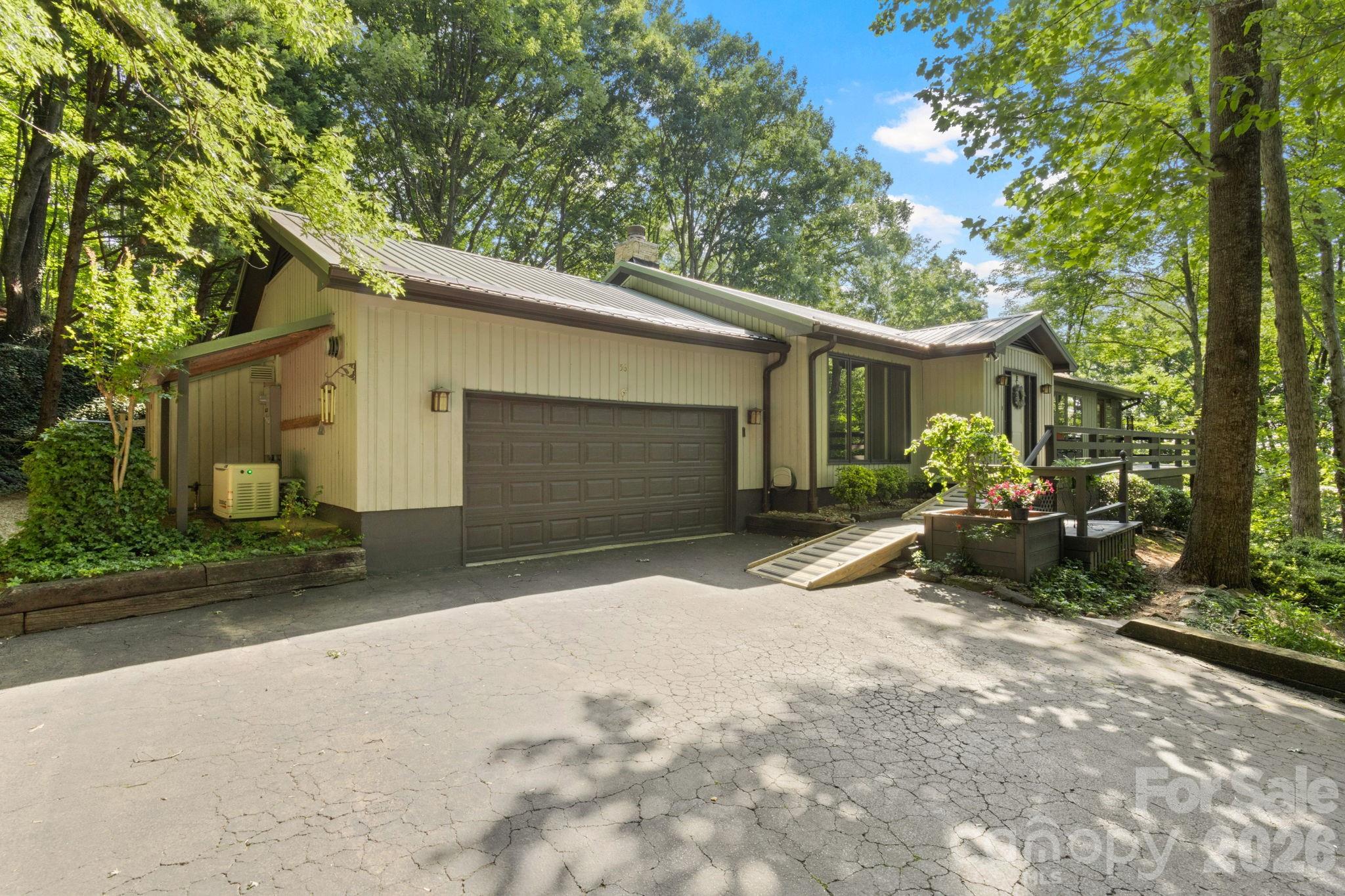 SELLER MOTIVATED!! Experience the perfect blend of privacy and convenience in this beautifully maintained home, ideally located just minutes from the charm of downtown Tryon and the quaint shops and dining of Landrum. Inside, the spacious living room welcomes you with rich hardwood floors, custom built-in shelving, a cozy gas log fireplace, and an open view into the bright breakfast area—creating an inviting space for both everyday living and entertaining. The updated galley-style kitchen is both stylish and functional, featuring new granite countertops, a tile backsplash, and stainless steel appliances. The adjoining breakfast area provides direct access to the back porch, making outdoor dining and grilling effortless. The primary suite is a true retreat, complete with hardwood floors, a generous walk-in closet, a beautifully tiled walk-in shower, and private access to the screened-in porch. Step outside to the expansive 30x10 screened porch—sure to become your favorite place to relax. With its charming tongue-and-groove ceiling and peaceful wooded views, it’s the perfect setting for morning coffee or evening unwinding. **Seller has moved out of state. Motivated and ready to sell!*