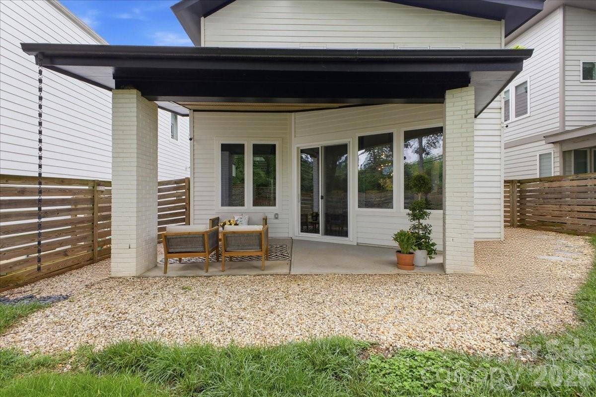 Welcome to this thoughtfully designed contemporary home with no HOA, ideally located just minutes from Plaza Midwood, Ovens Auditorium, Bojangles Coliseum, trolley access, and a quick commute into Uptown via Hwy 74. Offering the perfect blend of modern design, functionality, and energy efficiency, this 3-bedroom, 2.5-bath home combines comfort with smart living.

Inside, you’ll find an open and airy floor plan with 10’ ceilings on the main level, creating a spacious feel throughout. The kitchen and living areas were designed for both everyday living and entertaining, while the oversized primary suite features a spa-inspired walk-in shower with a rain head.

Built with efficiency and technology in mind, the home includes Ecobee smart thermostats with room sensors for customized comfort, whole-home water filtration, Martin Logan in-ceiling surround speakers, motorized stairwell blinds, blackout blinds in all bedrooms, and EV-ready electrical capacity with room for a 60A connection.

Outdoor spaces are equally inviting with a covered rear patio and shaded backyard ideal for relaxing or entertaining, along with beautifully maintained landscaping featuring Zoysia grass in the front yard and tall fescue in the rear. The oversized, fully finished two-car garage offers additional depth and width beyond a standard garage, creating exceptional flexibility for storage, workshop space, a home gym, or oversized vehicles while still comfortably accommodating everyday parking.

A rare combination of modern style, smart-home functionality, and in-town convenience in one of Charlotte’s most accessible locations.