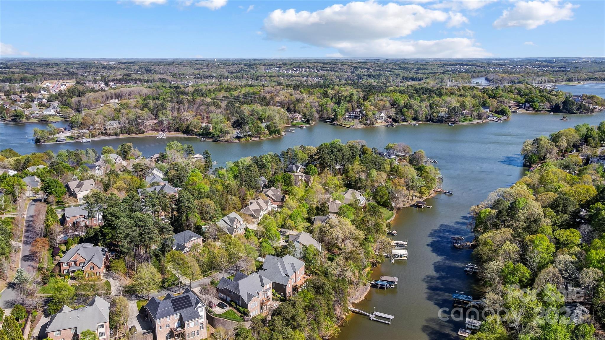 Indulge in the epitome of waterfront luxury living in Tega Cay. This exquisite residence exudes opulence at every turn, from its grand entrance with craftsman-style arched casement entries to its meticulously designed interiors. Revel in the culinary delights of the gourmet kitchen, boasting top-of-the-line Miele appliances, stunning granite countertops, and custom cabinetry fit for a chef's dream. Retreat to the sumptuous owner's suite, complete with a spa-like bathroom sanctuary. Entertain with flair in the basement billiard room or private theatre, perfect for hosting unforgettable gatherings. Basement level is fully finished as an independent secondary living space. Outside, bask in the serenity of your fenced yard, expansive upper deck, or enjoy leisurely days on the dock with lift, soak up the waterfront views or spend the afternoon casting a fishing line onto the quiet cove. Smart home features enhancing convenience and comfort present a lifestyle of luxury and sophistication.