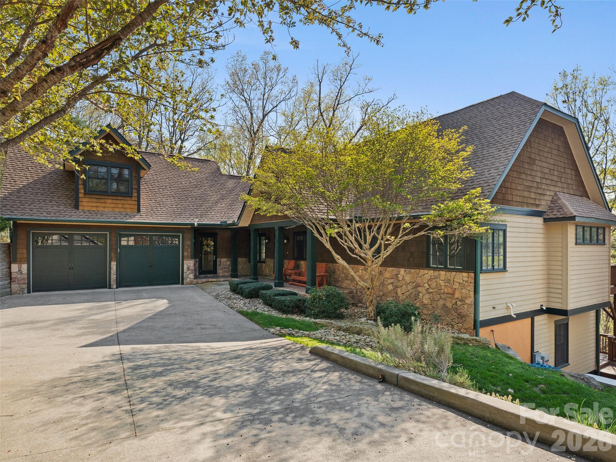 This stunning home sits on nearly 1.5 private acres just minutes from downtown Asheville, offering the perfect blend of luxury, space, and mountain living. With almost 4,000 SF, this light-filled home features hardwood floors throughout, expansive windows, and a highly functional layout designed for both everyday living and entertaining.

The main level welcomes you with an open-concept kitchen and dining area, seamlessly connected to the living room by a cozy gas fireplace. The spacious primary suite on the main level offers a true retreat with a garden tub, walk-in shower, and large walk-in closet. An additional bedroom, full bath, and laundry room complete the main floor.

Upstairs, the versatile bonus room (F.R.O.G.) above the garage is ideal for a home office, art studio, fitness room, or media space.

The fully finished basement provides exceptional flexibility with a large recreation room, three additional bedrooms, a full bath, and a generous storage area.

Enjoy outdoor living on the full-length decks on both the main and lower levels, ideal for entertaining or relaxing while taking in peaceful wooded surroundings and seasonal mountain views—with potential for expanded views through selective clearing.

Additional highlights include a two-car garage, low-maintenance landscaping, a generator, new roof in 2025, and a prime location close to Asheville dining, shopping, and outdoor recreation.

See the virtual tour: https://mls.kuu.la/share/collection/7MM6z?fs=1&vr=1&sd=1&autorotate=0.04&thumbs=1