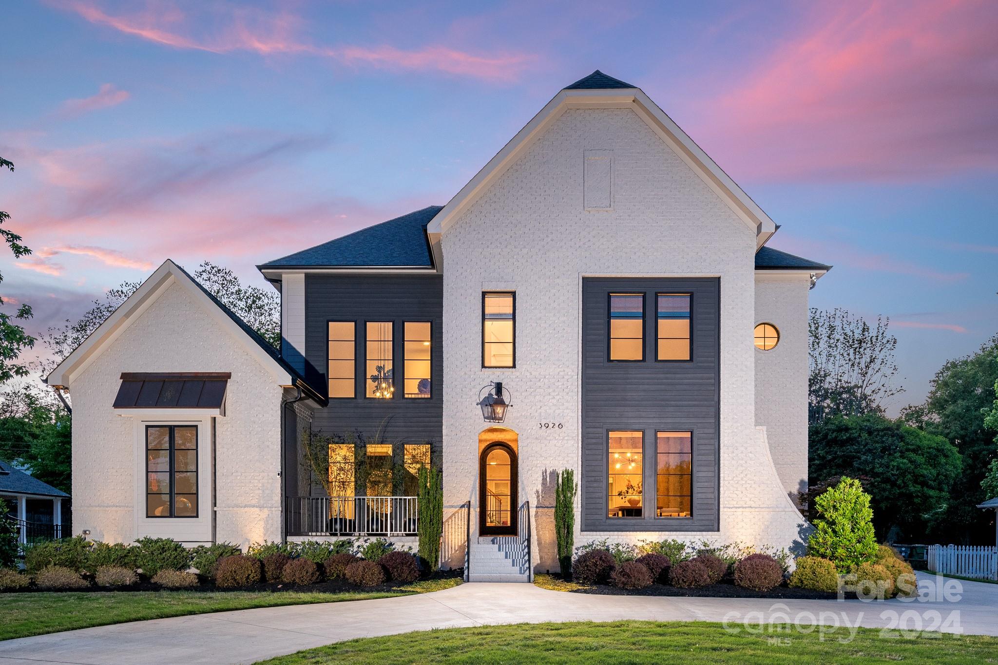 The epitome of SouthPark luxury living and situated at its threshold, this residence grants effortless access to premier amenities, including SP Mall, Symphony Park, Piedmont Town Center, and an array of fine dining. Crafted by Fairview Builders, this gem boasts a striking white painted brick facade with subtle gray wood accents. A grand entrance awaits, marked by an arched glass door that beckons guests into a double-height foyer, graced by a floating staircase. The heart of the home unfolds in an expansive great room, integrating the kitchen, breakfast nook, and living area, where custom built-ins and cast stone gas fireplace anchor the scene. The meticulous attention to detail extends outdoors. The current owner has transformed the backyard into a sanctuary with a saltwater pool and spa, accompanied by fire bowls and waterfalls, inviting serene relaxation. A bespoke louvered pavilion, complete with an outdoor kitchen, provides an idyllic setting for al fresco entertaining.