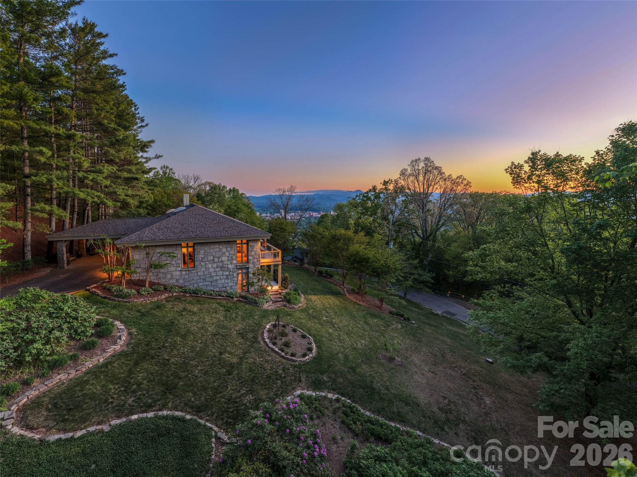Some homes are measured by square footage. Others are measured by the lives they have sheltered, the craftsmanship they preserve, and the stories they continue to tell.

Carefully designed across two beautifully situated lots on the coveted slopes of Sunset Mountain, 65 Crestwood Road was thoughtfully positioned to embrace sweeping views of the Blue Ridge Mountains, downtown Asheville, and unforgettable western sunsets. Gracefully integrated into the mountain's natural topography, the home reflects an era when architecture was guided by the land itself—allowing the residence to become part of the landscape rather than simply occupy it.

Originally constructed by Abbott Construction for the Pearlman family in 1971, every decision—from the home's placement and orientation to its enduring materials—demonstrates a commitment to craftsmanship, permanence, and timeless design. The residence was designed by architect Jan Wiegman, whose work was known for its thoughtful response to the mountain landscape, creating homes that blended naturally with their surroundings while maximizing light, views, and livability. At 65 Crestwood Road, that philosophy is evident in the home's graceful relationship to the land and its seamless connection between indoor and outdoor living.

The home was created during one of Asheville's most significant periods of residential architecture. During this era, architects and designers helped define the city's distinctive character by embracing the beauty of the Blue Ridge Mountains rather than competing with it. 

The result is a residence that feels both grand in its setting and intimately connected to the mountain that surrounds it—a home built not only to endure, but to be thoughtfully stewarded for generations to come.

4 Bedrooms | 3.5 Bathrooms | Expansive Porches | Mountain & City Views | Minutes to Downtown Asheville | Legacy Property on Sunset Mountain