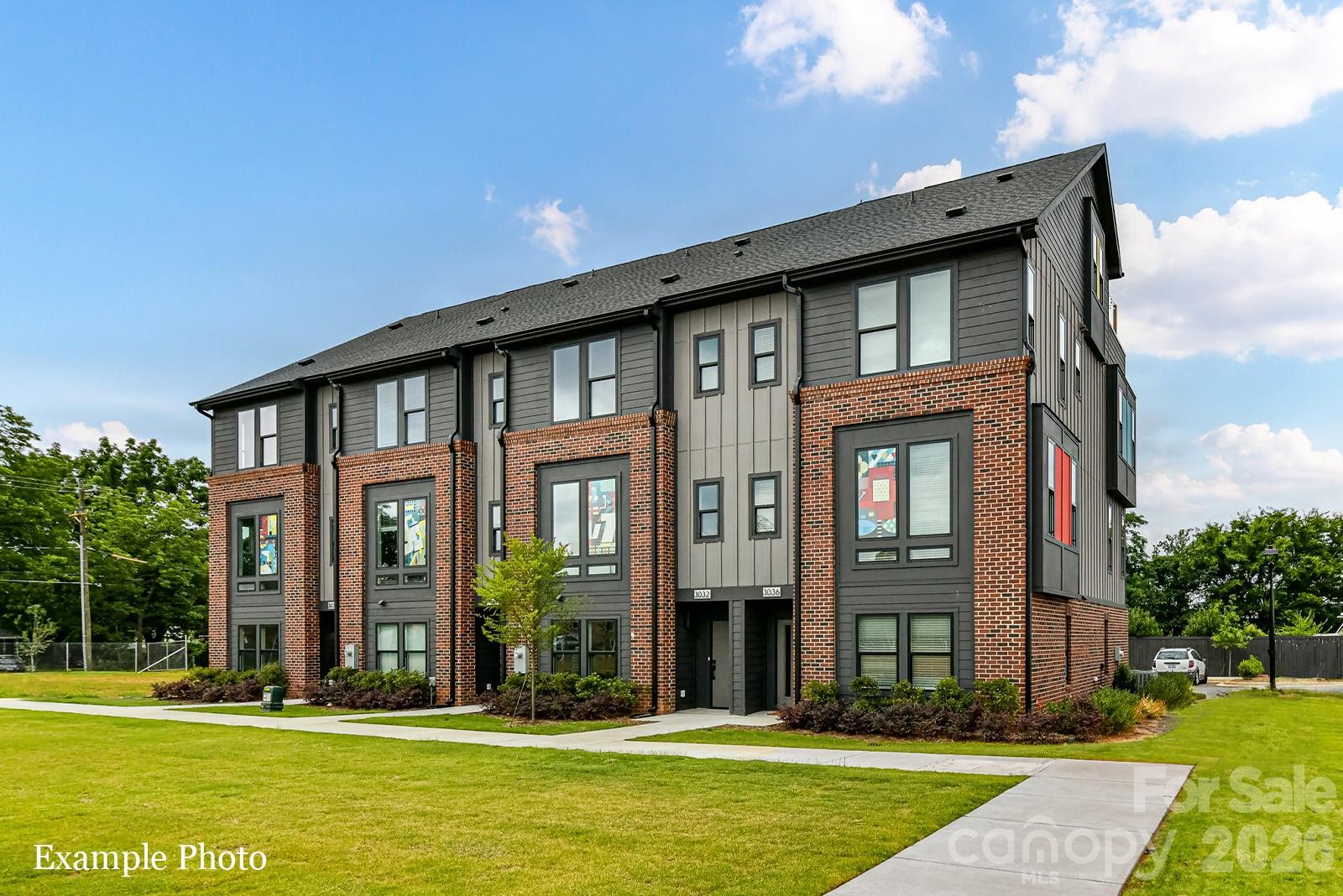 TREE TOP VIEWS & PREMIUM LOCATION JUST 2 BLOCKS TO CAMP NORTH END, LIVE IN A NEW, BEAUTIFUL TOWNHOME! INCENTIVE: Receive up to $20,000 in Flex Dollars. Discover Modern Industrial Living at "North End Terraces". A Unique Townhome Community of 69 Homes w/ Modern Design, Artful Architecture & FENCED IN DOG PARK. Nestled between Charlotte's thriving Arts District, NODA, and the bustling Central Business District of Uptown. This home has 4 bedrooms, 4 full and 1 half bath, 2 car attached garage with garage door opener and EV charger. Upscale finishes include 5-inch plank hardwood floors throughout, oak tread staircase, two-toned kitchen showcasing white shaker style cabinets paired with midnight blue island cabinets, white scalloped backsplash, quartz countertops, stainless steel appliances, range, dishwasher, microwave, distinctive lighting, and more! Enjoy urban living at its best close to shopping, restaurants and entertainment! 
 INVESTORS:NO RENTAL RESTRICTIONS.