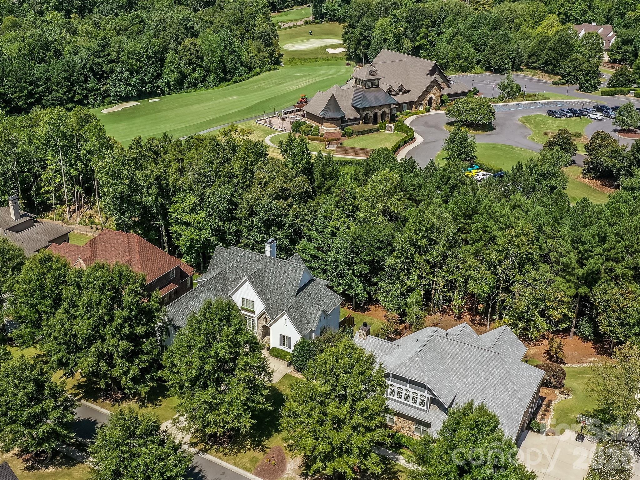 Welcome to The Palisades.  This amazing Championship Golf Community is situated conveniently on the South Side of Charlotte and is flanked by Lake Wylie which straddles the North & South Carolina State Lines. Ashton Oaks, is the premiere gated section of The Palisades and backs up to the French Inspired Palisades Country Club and Club House.  This French Provincial Styled Home has been completely updated from tip to tail!  There has been no stone left unturned. You will see as you pull into the courtyard style parking area that the home has had the complete exteriors painted.  The foyer welcomes you into this executive estate with all new site finished hardwood floors and is open to formal dining room and den.  The dining room has smooth arched ceilings, chair rail, crown molding, and custom plantation blinds. The den features coffered ceiling, box bay window, cast stone see through gas log fireplace, and access to the covered rear porch. The gourmet kitchen has Honed Carrera Marble countertops, huge island, built-in KitchenAid Fridge, Wolf Gas Range/Oven, Subway Tile Backsplash, New White Cabinets, and more!  Added features are the walk-in pantry, butler's pantry, and large private laundry. The main floor primary has vaulted ceiling, new site finished hardwood flooring, plantation blinds, recessed lighting, and crown molding. The primary bath has tile floor, custom vanity with storage tower, soaking tub, and walk-in shower.  The 2nd floor features 3 spacious guest rooms all with site finished hardwood flooring and 2 large guest  baths as well as a large bonus room and 2nd floor home office.  Plantation blinds adorn all of the 2nd floor windows as well.  The basement is designed with entertaining in mind!  With 2nd kitchen/bar, large great room, and huge den/study with stacked stone see through gas log fireplace, you will never run out of room to gather! The basement also features a guest room with a full bathroom that is perfect for a large home gym! The dual covered rear porches overlook the treed areas between the home and the Palisades Country Club! Gated community entry ensures privacy & security!  Take a quick golf cart ride to the club and enjoy all that membership has to offer!  Schedule a tour to see this amazing home today!
