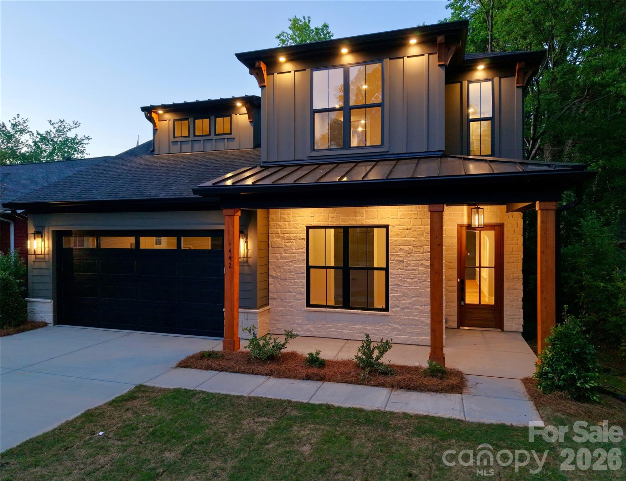 UNBEATABLE URBAN LOCATION! Directly across from Camp North End and just a half mile to Optimist Hall! Modern design in Charlotte’s vibrant Lockwood neighborhood. An extra-wide street with a mature tree canopy. Two miles to the city center. This stunning 4-bedroom, 4-bathroom residence features an expansive open floor plan with a dramatic 2-story great room including a gorgeous fireplace, custom wood trim and mantel, 10ft ceilings on the main level, and 8ft doors throughout both floors. The gourmet kitchen is a chef’s dream, beautiful sand color cabinets to ceiling with glass LED lights, under cabinet lighting, Ivoritaj quartz countertops, a striking waterfall island, a custom stained furniture hood, and high-end KitchenAid appliances—including a gas cooktop, stainless refrigerator, wall oven and microwave. Crown molding throughout first floor, wood trim around windows, lots of oversized windows for natural lighting. 
The main level offers a rare dual-suite layout: a lavish Primary retreat with a spa-inspired en-suite featuring a stand alone soaking tub, massive walk-in shower (rain head, dual heads, and handheld), plus a secondary full guest suite. Upstairs, you’ll find a versatile loft and a private home office enclosed by elegant glass French doors. Every bedroom functions as a private oasis with its own dedicated en-suite bath and engineered hardwoods throughout the entire home. Step outside through 12ft wide sliding glass doors to a screened covered porch with wood ceiling accent, overlooking a large flat backyard fully enclosed by a custom wood 8ft horizontal privacy fence backyard and 6ft privacy fence along the sides. Seller will offer 2-10 home warranty. Agent is owner.