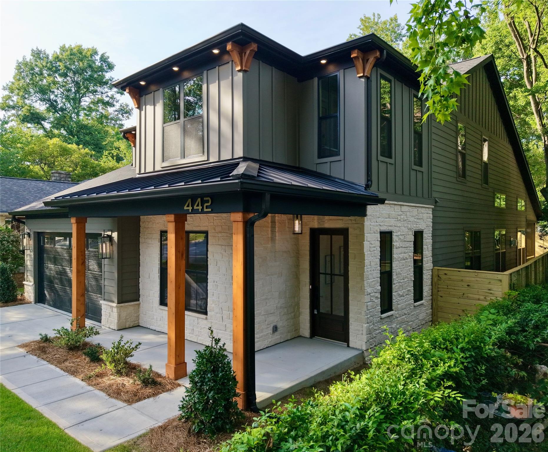 Across the street from Camp North End, just 1/2 mile to Optimist Hall and only 1.5 miles to Uptown Charlotte. This exceptional new construction home offers, 4 bedrooms, 4 full baths, large loft and private home office, oversized 2-car garage highlighted by a rare main-level primary suite and guest suite, along with a dramatic 20+ foot vaulted great room filled with natural light. Situated on an extra-wide street with a mature tree canopy in Charlotte’s thriving Lockwood neighborhood, the home delivers luxury living in a premier urban location.
The open-concept layout centers around the two-story vaulted great room with a floor-to-ceiling fireplace and oversized windows that create an open, light-filled living experience. The main level features 10-foot ceilings, 8-foot doors, extensive trim details, crown molding, and engineered hardwood flooring throughout.
The kitchen showcases ceiling-height cabinetry with LED glass display cabinets, under-cabinet lighting, Ivoritaj quartz countertops, a waterfall island, custom stained wood hood, and a premium, stainless steel KitchenAid appliance package including a gas cooktop, wall oven, microwave, and refrigerator.
The primary suite includes a spa-style bath with freestanding soaking tub, oversized walk-in shower, and spacious walk-in closet. A private guest suite is also located on the main level. Upstairs offers two additional en-suite bedrooms, a versatile loft, and a dedicated home office with glass French doors.
Outdoor living is elevated with 12-foot sliding glass doors leading to a screened porch with wood-accent ceiling overlooking a large, flat backyard enclosed by a custom 8-foot horizontal privacy fence.
Additional features include custom closets, designer window trim, abundant storage, and a 2-10 Home Warranty. Minutes to NoDa, Plaza Midwood, and Uptown Charlotte. Agent/Owner.
