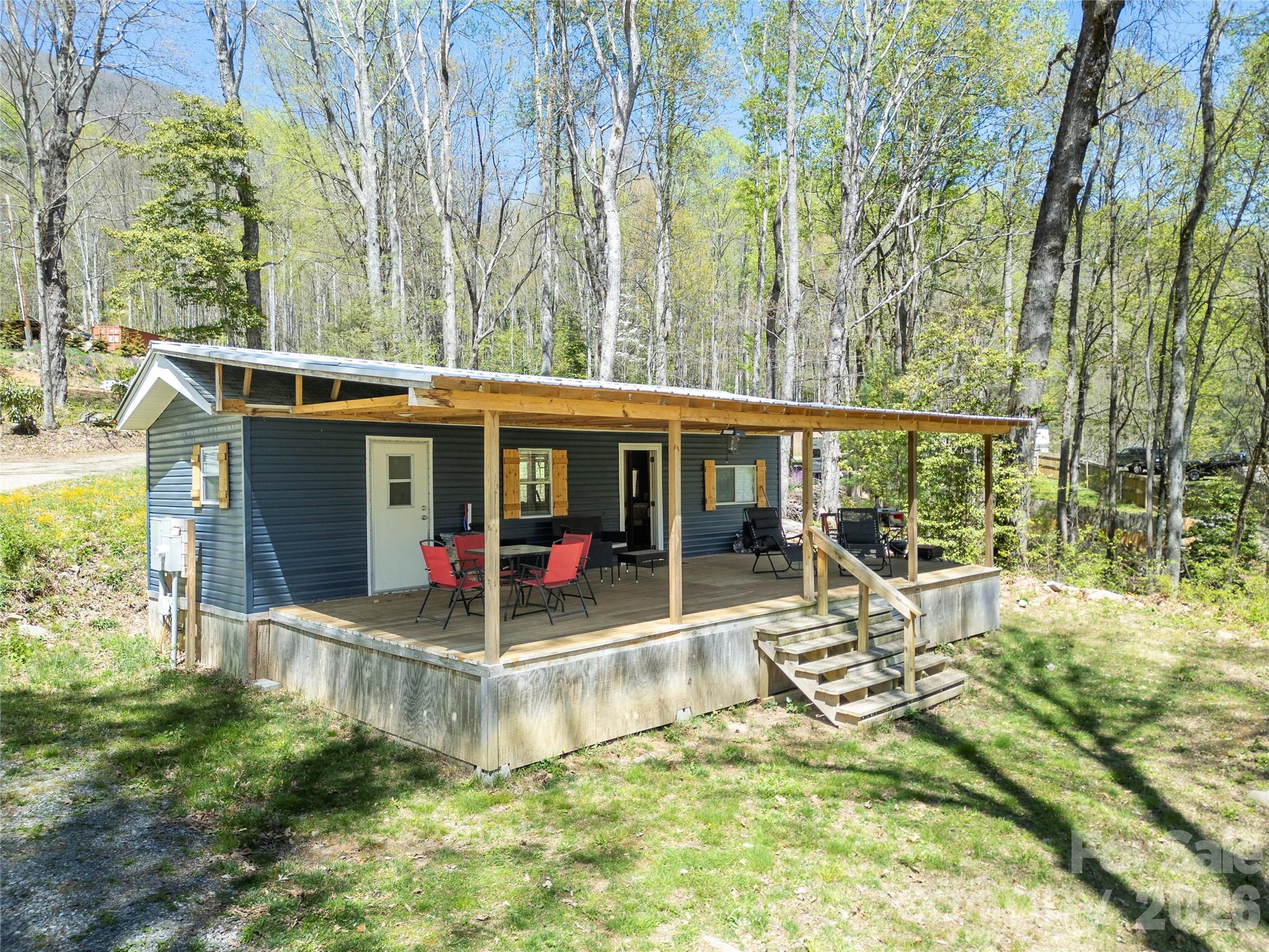 Turnkey mountain getaway with short-term rental potential—fully furnished and ready to go.

Tucked into a quiet, wooded setting in Maggie Valley, this Chariot Eagle park model (approx. 33x12) on deeded land offers a rare opportunity for a low-maintenance retreat, investment property, or personal escape. With 2 bedrooms plus additional bunk space, a 2-bedroom septic (2022), and 1 full bath, the layout is designed to comfortably accommodate guests while maximizing usability.

Major updates have already been completed, including a 2-ton heat pump (2022), updated electrical throughout with 200 amp service, and a metal roof (2022). The home sits on a permanent foundation with a full Certificate of Occupancy.

A private well is scheduled for installation in May 2026, and Spectrum high-speed internet is available—making this a strong option for both personal use and short-term rental guests.

Offered fully furnished, this is a true turnkey opportunity—just bring your plans and start enjoying or renting right away.

Located minutes from Maggie Valley, with easy access to the Blue Ridge Parkway, Cataloochee Ski Area, and Cherokee, this property is central to some of the area's best access points.