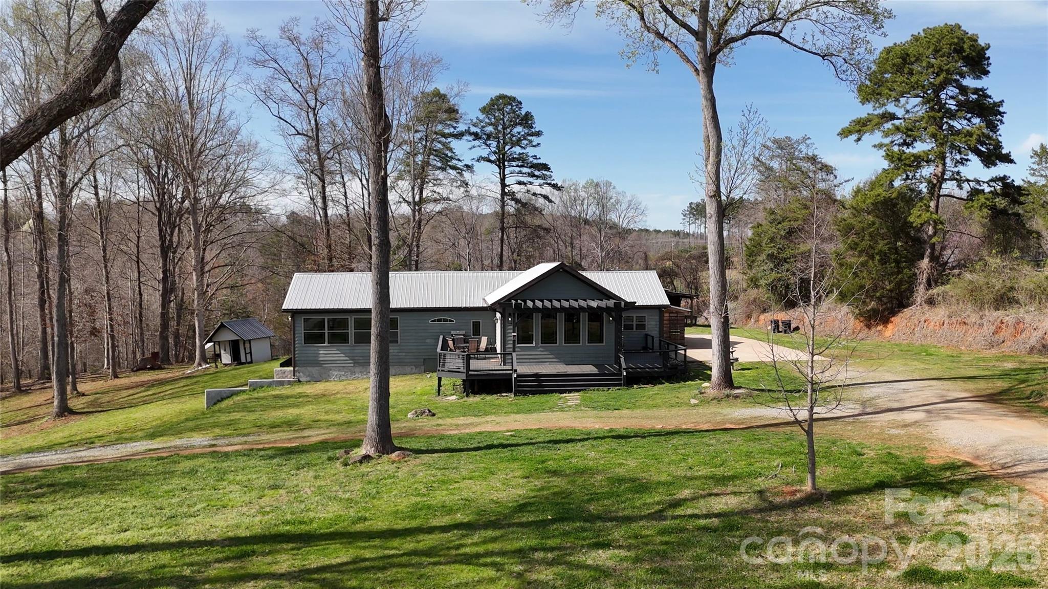 *PRIME LOCATION * PRIME CONDITION * A Completely updated and renovated home, only 2.5 miles to the entrance of TIEC - a simple 4 minute drive!!  Home is being used as a Short Term Rental (On Air B & B, & VRBO) and fetching upwards of $444 per night!  Owner says the season has begun and runs through November!!  Home will be sold furnished, so, new owner can take over and keep the business running smoothly.  Home features 4 bedrooms, 2 full baths, all new flooring, fixtures, countertops, floor joists, metal roof, and amazing wrap around deck!!  The home has many "smart phone operated home" I.T. features:  Security cameras, security system, lights, sound, and more.  The Kitchen, Dining Area, and Living Room are all open to one another - perfect for entertaining!  The oversized kitchen has a 6 burner gas stove, a beverage station, a coffee bar, a large island, built in China cabinet, double ovens, and a reverse osmosis water dispenser!!  The primary bedroom has a walk-in closet that runs the length of the room, the primary bath has a double vanity, bamboo floors, and a big jetted tub for soaking!  The hall bath has a low entry tiled shower with glass surround.  The exterior of the home has all new designer windows, a metal roof and a deck that "keeps going"!  The property features a 2 car garage / workshop / or storage building.  The basement is partially finished and used as the "Owners Quarters" for their belongings and personal effects.  Home does not need to stay a Short Term Rental - The owner is currently only booking 30 - 60 days out to give the buyer options.  Home has fiber optic internet with Starlink back-up.  Well and dumpster are shared with neighbor. Call With Questions about this remarkable opportunity!