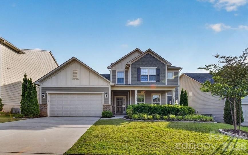 Welcome to 11033 Chapel Cove, where the first thing you notice is what you do not see. No staircase crowding the entry. Just an open sightline that pulls you straight through the home. To the right, a private office behind French doors gives you a quiet place to work, read, or close the door on the day.
The floor plan opens into a bright main living area built around an oversized kitchen and dining space. Rich espresso cabinetry, granite counters, stainless steel appliances, recessed lighting, and a large center island with seating make this the kind of kitchen that handles a Tuesday night dinner and a holiday table with equal ease. Cabinet and counter space runs the length of the room, and the dining area sits in natural light with an easy flow into the great room and its gas fireplace. The main level primary suite is the quiet luxury of this home. A spa style bath with tile flooring, a soaking tub, a separate tiled shower, dual vanities with granite, and dark cabinetry that ties to the finishes throughout. Primary on the main, with four more bedrooms and a large bonus room upstairs. The everyday details are handled. A laundry room with utility sink, a mud room and drop zone, and a built in desk and coffee bar that works as a command center, homework station, or morning espresso stop. Rich wood toned plank flooring, fresh paint, neutral tones, and generous natural light keep the home feeling clean and move in ready. Out back, a fully fenced yard with real depth and a covered hardtop pavilion set over an expanded concrete patio. Room to grill, gather, and unwind with the privacy of a fenced setting. The pavilion conveys with the home. Chapel Cove wraps it all in lifestyle. Lake access and kayak launch, clubhouse, pool, playground, and courts for tennis and basketball. You are minutes from Lake Wylie, Charlotte Premium Outlets, dining, major commuter routes, Charlotte Douglas International Airport, and the U.S. National Whitewater Center. Five bedrooms, a private office, a main level primary suite, an open entertaining kitchen, an upstairs bonus room, and a fully fenced backyard in one of the area's most sought after communities. 11033 Chapel Cove is ready for its next chapter.
