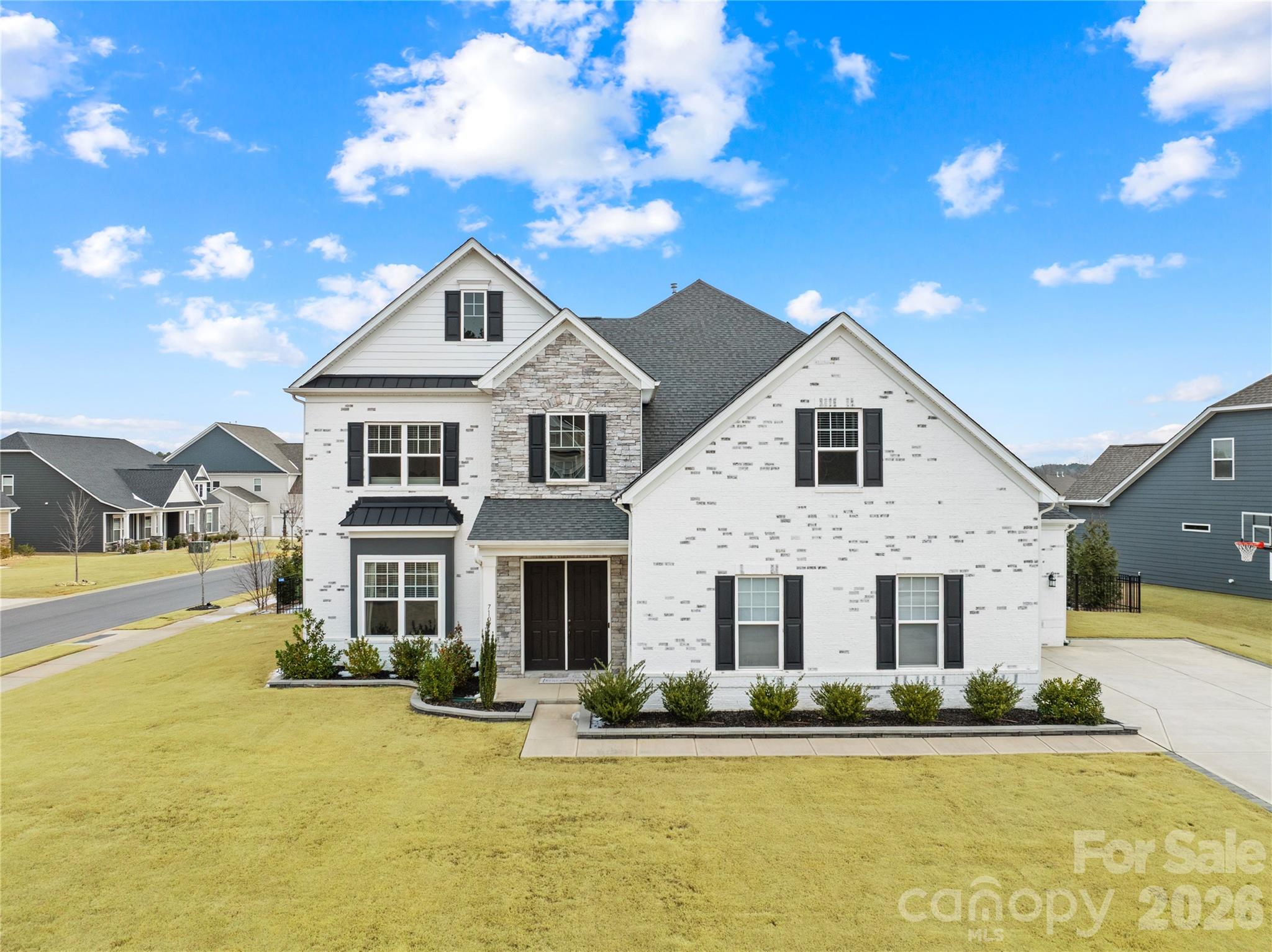 Welcome to 7107 Sumters Camp Trail in beautiful Indian Land, located in the exclusive community of The Estates at Covington, a stunning and spacious home offering 4,628 square feet of thoughtfully designed living space on a corner lot with exceptional upgrades and privacy.
Built in 2022, this impressive 5 bedroom, 4.5 bathroom home blends elegant design with modern functionality. The inviting living room features coffered ceilings and large windows, creating a bright and sophisticated gathering space.
The heart of the home is the gourmet kitchen, complete with white cabinetry, granite countertops, an oversized island, walk-in pantry, and additional storage space, making it perfect for both everyday living and entertaining.
Just off the kitchen, the elegant dining room includes a dry bar with a beverage refrigerator and sliding doors that open to the screened porch, seamlessly blending indoor and outdoor living, perfect for relaxing, dining, or entertaining year round.
The main level also features a private office with French doors, a guest bedroom with a full bathroom, a versatile study behind the living room that can be used as a second office, playroom, or workout space, and a convenient drop zone for coats, backpacks, and shoes.
Upstairs, you’ll find even more flexible living space including a loft and an additional flex room ideal for a media room, game room, or playroom. The spacious laundry room is also conveniently located on the second floor. The luxurious owner’s suite offers a peaceful retreat with dual walk-in closets, a spa-like bathroom with dual vanities, a soaking tub, and a large, tiled shower. Additional upstairs bedrooms include one bedroom with a full bathroom and two bedrooms connected by a Jack-and-Jill bathroom.
Step outside to enjoy the fully fenced backyard, enhanced by a perimeter of privacy trees planted along the fence line, creating a peaceful and private outdoor oasis. The screened porch extends your living space outdoors and is ideal for enjoying the fresh air in comfort. The property also includes an irrigation system to maintain the landscaping. This home is loaded with valuable upgrades including fully paid-off solar panels installed in 2024 and a tankless gas water heater, offering energy efficiency and long-term savings.
Residents of The Estates at Covington enjoy access to fantastic community amenities, including a clubhouse, outdoor pool, and playground, all included through the HOA.
Located just minutes from the thriving Ballantyne area of Charlotte, this home offers convenient access to shopping, dining, entertainment, and outdoor activities while still enjoying the charm and space of Indian Land. The area is also known for its highly rated schools, making it a desirable place to call home. This exceptional property truly offers space, luxury, privacy, and location all in one, a dream home designed for modern living.