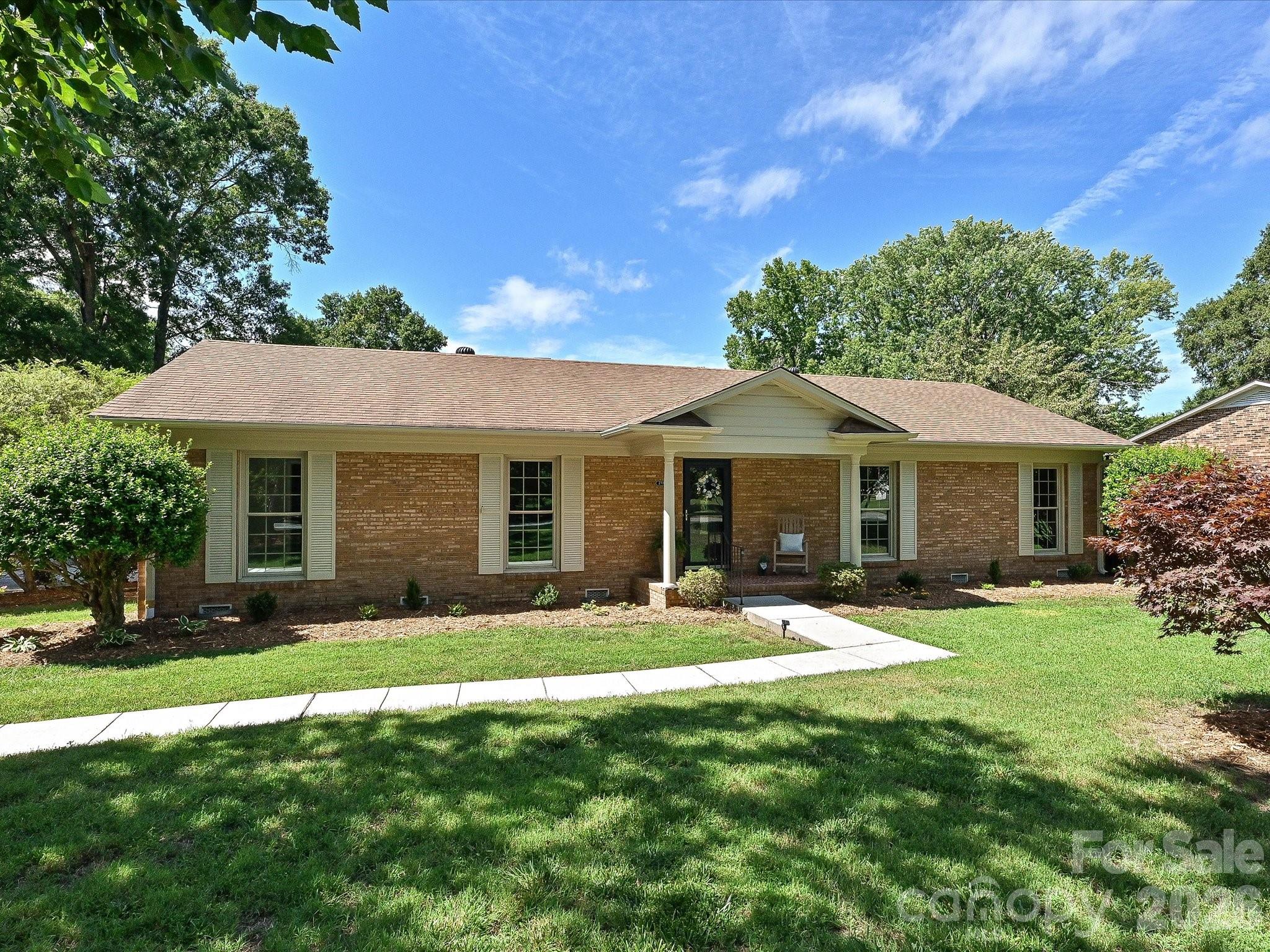 Beautifully updated traditional brick ranch home situated on a large, level lot in the desirable Coulwood neighborhood! This move-in ready property features gorgeous hardwood floors throughout and fresh custom interior paint paired with new light fixtures. The updated kitchen boasts brand-new countertops, new flooring, freshly painted cabinets, and sleek stainless steel appliances. Both bathrooms have been stylishly renovated, including a hall bath with new tile and cabinetry, and a primary suite featuring a brand-new shower and double vanity. Cozy up in the spacious den by the brick fireplace with gas logs. A large, functional laundry room offers excellent extra storage space.The exterior shines with fresh paint, an updated roof, and energy-efficient replacement windows. Parking and storage are a dream with an oversized double carport—complete with an attached workshop and perfect for outdoor gatherings. Additionally, the property features a separate storage building and a detached, air-conditioned garage with a roll-up door that is ideal for a golf cart, hobby shop, or extra storage. Schedule your tour today!
