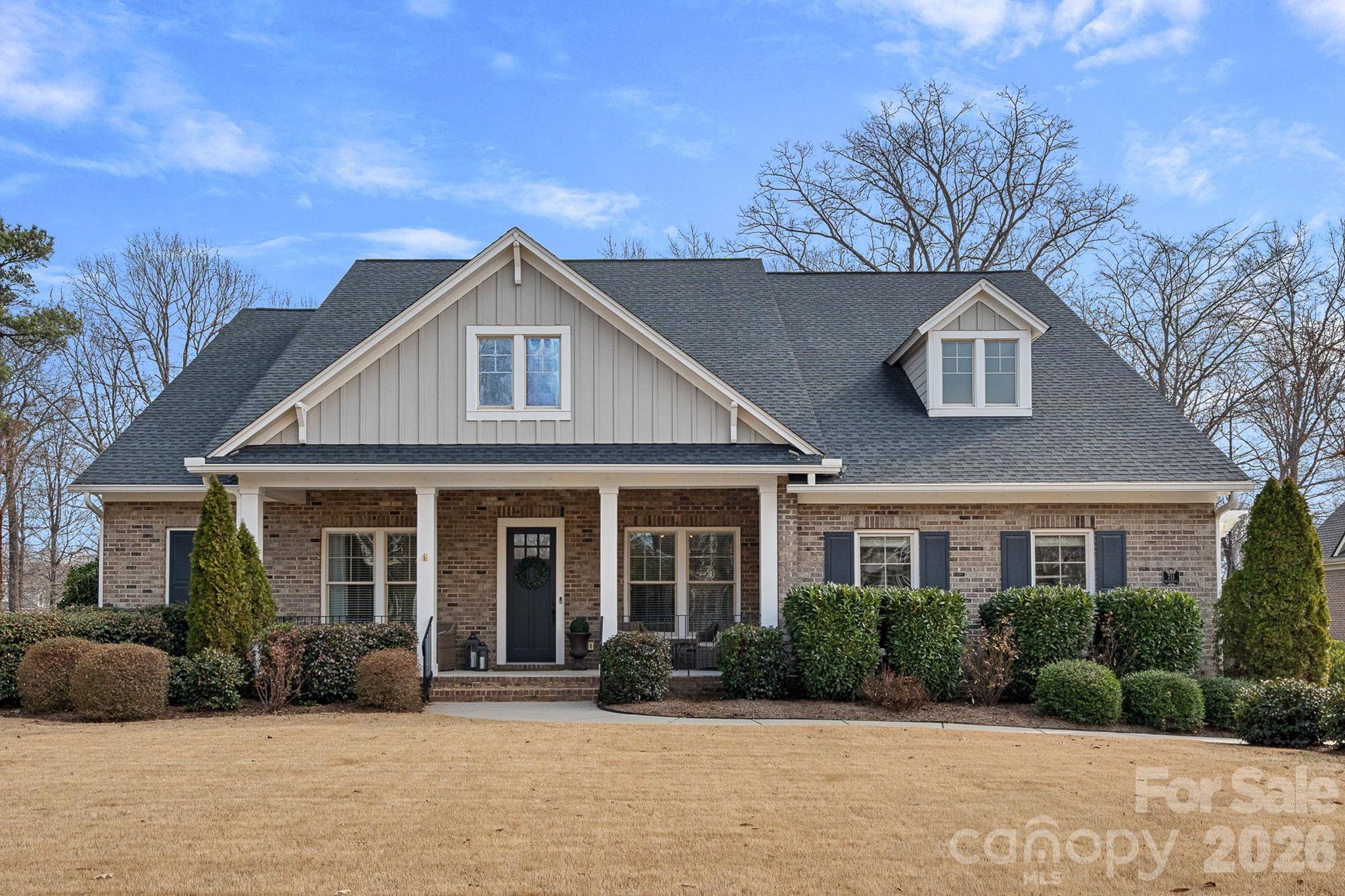 WARNING- you are going to fall in love with this property!  Perfectly positioned on the 10th tee of the Springfield golf course, this home offers the lifestyle buyers dream about- but rarely find.  With four spacious bedrooms on the main floor, each featuring its own full bathroom, this home provides comfort and privacy for family and guests alike. The primary suite is conveniently located on the main level and features a beautifully appointed bathroom designed for relaxation, and an oversized closet with wood shelving.  The heart of the home is the open kitchen, complete with a large center island, abundant workspace, and seamless flow into the main living areas—ideal for entertaining or everyday living. Upstairs, a huge bonus room with its own full bathroom offers endless flexibility as a media room, guest retreat, home gym, or office. Step outside to experience one of the home’s most impressive features: the outdoor living area. Imagine enjoying a beautiful golf course view every day with a screened-in porch featuring a cozy fireplace with gas logs, an outdoor kitchen area with grill plumbed to natural gas, a relaxing hot tub, and an expansive patio centered around a stunning gas firepit—all overlooking the scenic golf course.  This home is located within a short walking distance to both the community pool and tennis/pickleball courts,  and the golf course.  Residents receive membership to the Anne Springs Close Greenway just across the street, offering miles of trails, recreation, and natural beauty.  Close to shopping, restaurants, and minutes to I-77 for easy access to all that Charlotte has to offer.  Elevate your lifestyle with this remarkable golf course home offering luxury, flexibility, and unforgettable outdoor living.