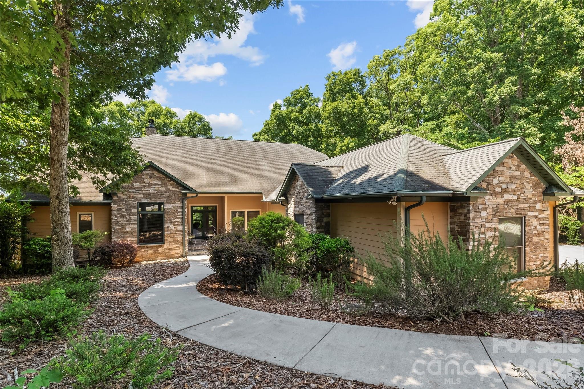 Welcome to 172 Lawsons Lookout! Nestled within the gated community of The Springs, this beautiful 3-bedroom, 3.5-bath home with a 3-car garage is situated on 2.29 acres and offers seasonal long-range views. The home's exterior features a blend of brick, Hardie siding, and stone. Step inside to discover bamboo flooring, vaulted ceilings in the living room, and a floor-to-ceiling stone wood-burning fireplace. The spacious primary suite provides a peaceful retreat with access to the deck and en suite bathroom. Enjoy your morning coffee or unwind at sunset from the inviting 60' x 10' screened-in deck, complete with a hot tub. The basement is ideal for entertaining, offering just over 1,000 square feet of finished living space, including a potential fourth bedroom or flexible-use area. Additionally, the basement includes more than 1,400 square feet of unfinished space featuring ample storage, a concrete-encased panic room/wine cellar, and a workshop.