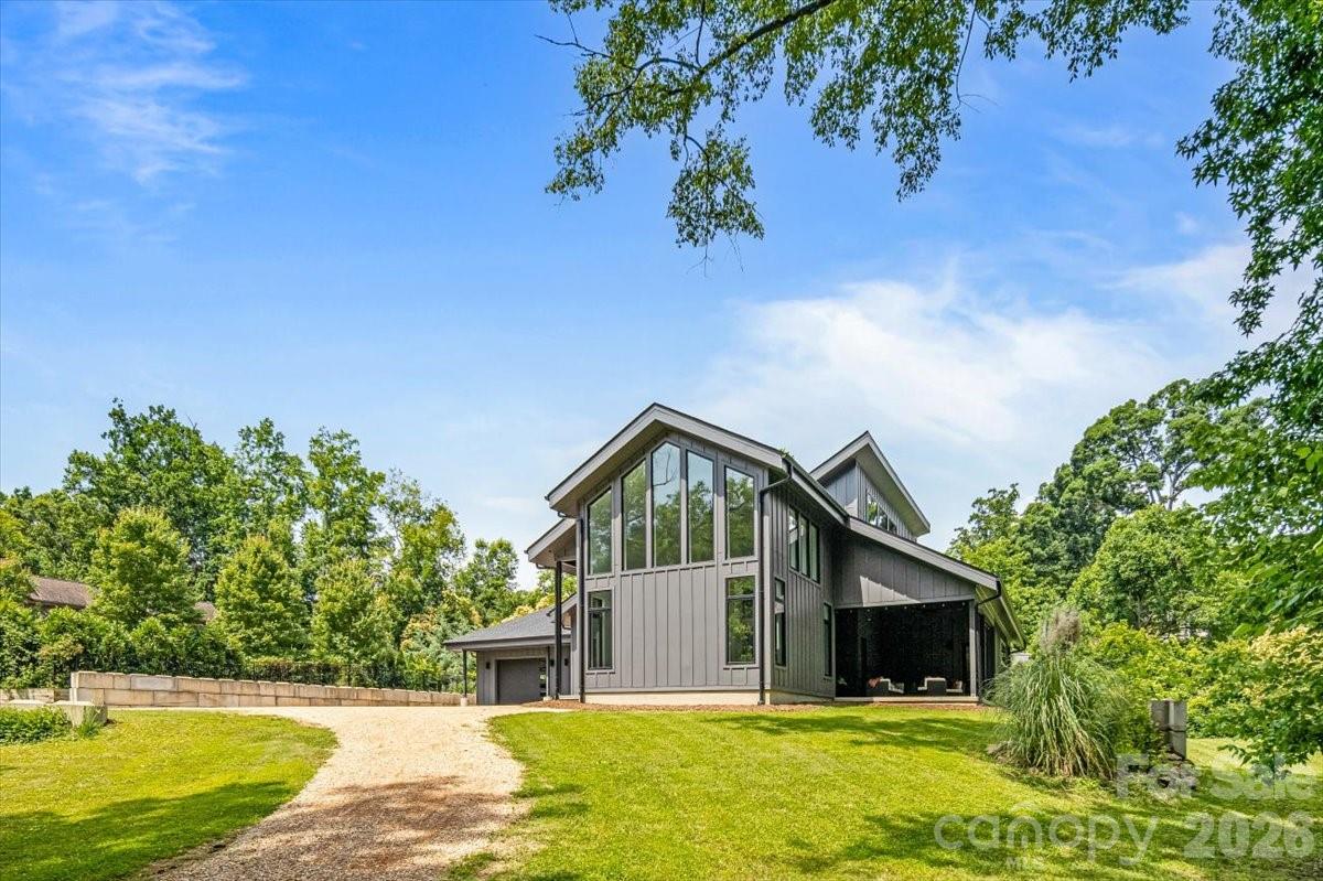 Experience a rare opportunity to own a custom-built residence in Charlotte's beloved Myers Park neighborhood showcasing energy efficiency, striking architectural design, and extraordinary attention to detail, while offering the unique ability to complete select finishing touches and personalize decorative elements to your own vision. Delight in all of the architectural details such as coveted cathedral ceilings with floor to ceiling windows, an open steel and wood tread staircase, concrete flooring, floating vanities, lofts in both upper-level bedrooms and much more. This home embodies modern living at its finest all the while keeping you connected to the nearby conveniences of an established neighborhood and its abundant surrounding amenities.

Set on an extraordinarily rare wooded 1.65-acre lot in Myers Park (just minutes from Freedom Park), the property offers private rear views of a neighborhood pond, abundant birdwatching and wildlife, and a peaceful natural setting that is nearly impossible to find in this coveted location.

The home features 5 bedrooms and 3.5 baths, including three bedrooms on the main level. Step inside to a dramatic open living space anchored by a soaring 25-foot ceiling in the great room. Walls of windows frame the stunning treescape and fill the home with natural light, while the great room flows seamlessly into the dining area and chef’s kitchen featuring sleek black cabinetry, a center island with prep sink, and premium appliances.

Modern French doors lead to an oversized covered porch, already designed with outdoor kitchen potential, creating an effortless indoor-outdoor lifestyle. Multiple flexible living spaces include a sunlit sitting room at the entry, a versatile room ideal for a home office, gym, or hobby space, plus an upper-level loft offering generous bonus living space.

The main-level primary suite is a true retreat, complete with vaulted ceilings, dual walk-in closets, and a spa-inspired bath featuring a floating vanity, walk-in shower with operable skylight, and access to a private outdoor shower.

The rear grounds offer ample space for a future private pool and spa, further enhancing the home’s exceptional indoor-outdoor potential. Offering remarkable privacy in the heart of Myers Park, this one-of-a-kind property is conveniently located just minutes from Uptown, Freedom Park, Dilworth, Charlotte Douglas Airport, as well as many top rated private and public schools. Plus it's just down the street from greenway access.