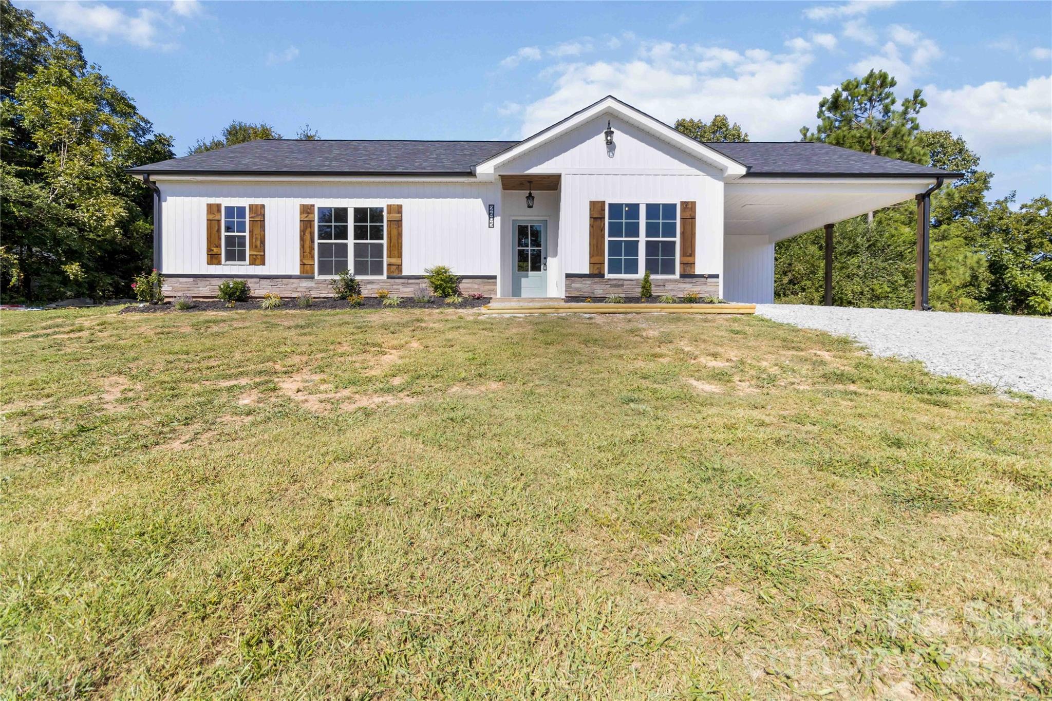 Welcome to this beautiful new construction home offering the perfect blend of modern design and peaceful rural living. Featuring 3 bedrooms, 2 bathrooms, and 1,537 heated square feet, this thoughtfully crafted home sits on approximately 6.26 acres, providing plenty of space and a sense of privacy. The eye-catching board-and-batten exterior adds standout curb appeal, while the covered back porch is an ideal spot to unwind and enjoy the quiet surroundings. Inside, the open, light-filled layout is perfect for everyday living and entertaining. Luxury vinyl plank flooring flows throughout, complementing the bright kitchen with granite countertops, stainless steel appliances, and a spacious design that connects seamlessly to the living and dining areas. The primary suite offers comfort and convenience with a well-finished bath and generous storage. An attached carport adds everyday functionality, and additional acreage may be available for purchase to expand your property. Don’t miss the opportunity to own this brand-new home! *** Seller has added an additional 4.02 acres to make a total of 6.26 acres.