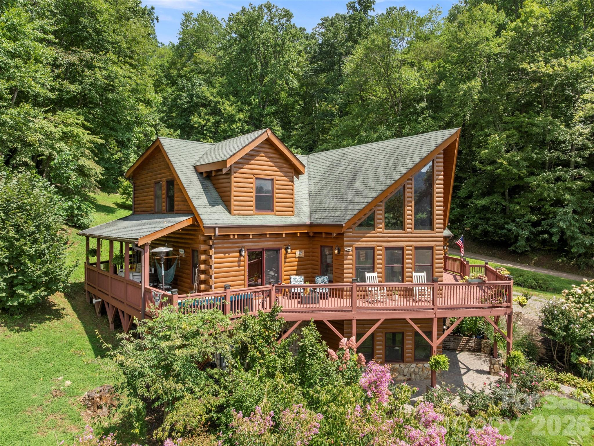 OPEN HOUSE Sunday, May 17.  2-4 pm.  Showings available by appointment with 24 hour notice after 4/17. Nestled within the gated community of Cobblers Knob, this handcrafted cabin is a true gem that beautifully marries rustic charm with elegant living. Once inside, you're greeted by the warm embrace of natural wood beams and rich, handcrafted finishes. The grand stone fireplace serves as the heart of the living space, inviting you to unwind. With ample natural light streaming in through large windows, the open floor plan is spacious and airy. On the main level, an expansive deck offers stunning views of the surrounding landscape, perfect for morning coffee or evening stargazing. The kitchen features granite countertops, breakfast bar and stainless steel appliances. The primary suite is a luxurious retreat, featuring a jetted tub and a tiled custom shower, offering a spa-like experience. Venturing upstairs, you’ll find a game room loft space designed for versatility. The lower basement level provides true bonus space. In addition, the property includes a two-car garage with additional finished square footage above. This area is perfect for working remotely or a flexible space. Landscaping. Sellers offering $5,000.00 flooring allowance.