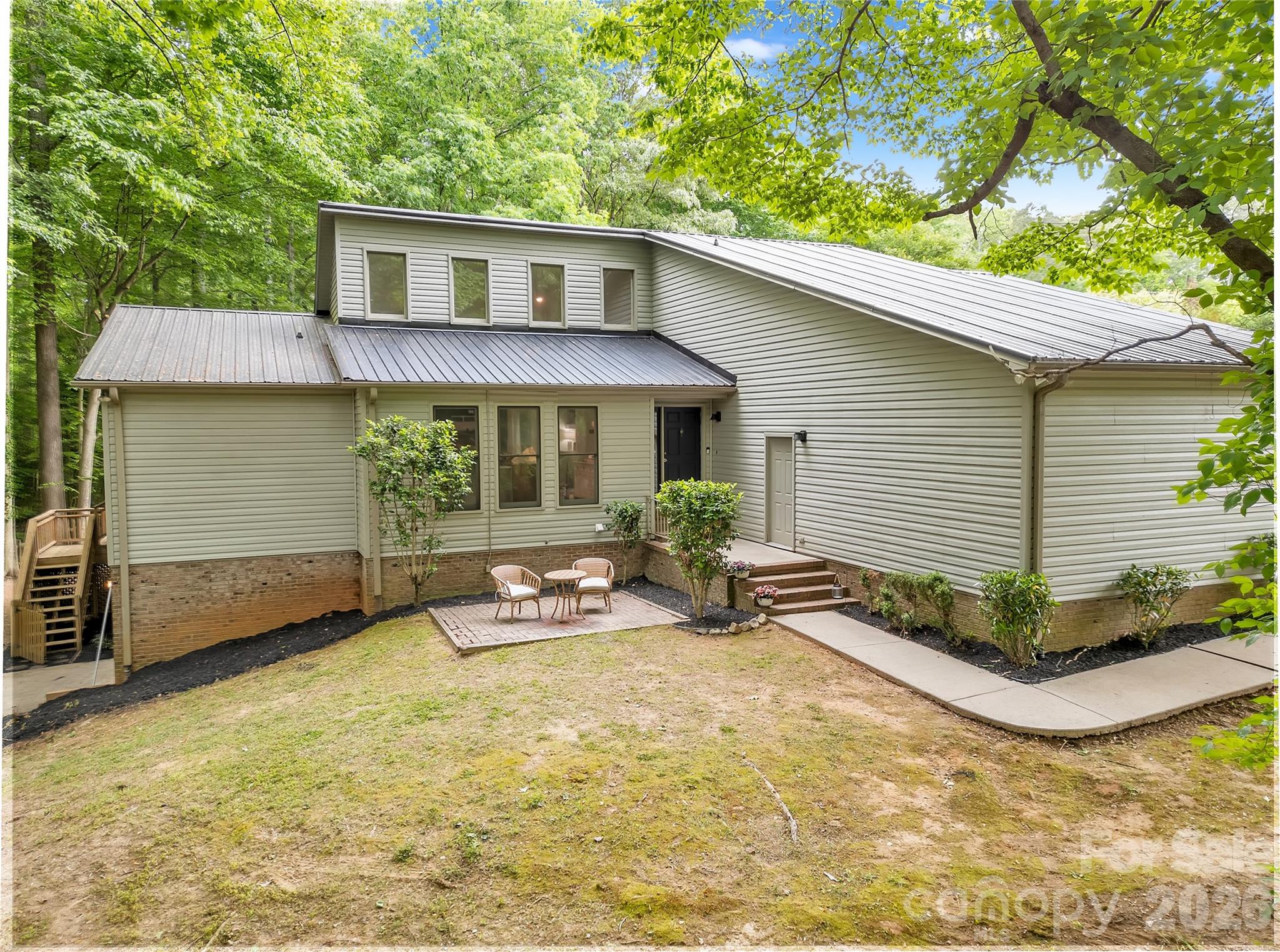 Charming home on over an acre in the desirable Spencer Woods community of Dallas. Enjoy a peaceful wooded setting with plenty of indoor and outdoor space. Main level features a spacious living area with fireplace, updated kitchen and bathrooms, and comfortable bedrooms. Finished lower level includes a bedroom, full bath, second kitchen, additional washer/dryer, and office area—ideal for a guest suite, in-law quarters, or bonus space. Large multi-tier deck overlooks the private backyard, perfect for entertaining or relaxing. Oversized two-car garage offers ample storage. Property also offers potential for Private Residential Quarters (PRQ), allowing for a secondary living space, detached garage, workshop, or storage building. Convenient to shopping, dining, and commuter routes while maintaining a quiet residential feel.