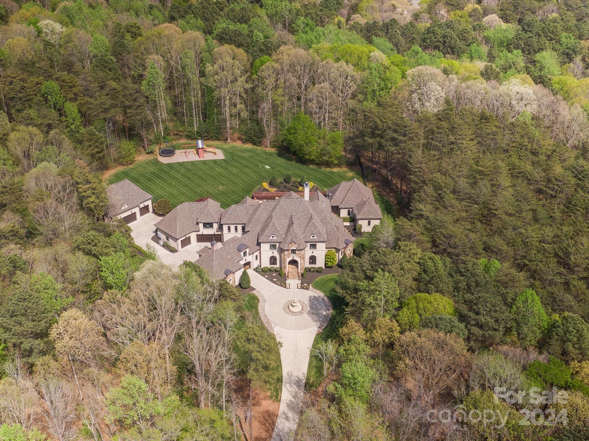Nestled in The Sanctuary's prestigious enclave, this European-style mansion custom built by Kingswood Custom Homes stands as a paragon of luxury. Spanning 12,500 sq ft under roof on a lush 7-acre estate, it offers unparalleled privacy and tranquility.  A sweeping 500ft driveway through private gates leads to this architectural marvel, boasting an eight-car garage. At its core, a lavish pool and spa, surrounded by pristine gardens, are complemented by a grand home gym w/ full sauna & steam room for ultimate wellness experience.  The grand interior features a dramatic foyer w/ soaring ceilings, Romeo & Juliet staircase, custom moldings / finishes, setting the stage for a refined open-plan living. The home includes a state-of-the-art theater & a unique two-lane automated shooting range. Luxurious living quarters, including a palatial 1st floor primary suite w/ en-suite bath spanning the length of the home.  This estate combines secluded grandeur w/ proximity to Charlotte's vibrant city.