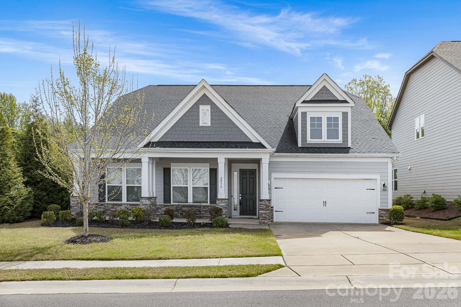 Stunning 1.5-story Arts & Crafts home featuring an open and spacious floor plan with 5 bedrooms and 3 full bathrooms, including a luxurious Owner’s Suite and two additional bedrooms on the main level. Ideally situated just minutes from Fort Mill and Ballantyne, this home offers convenient access to top-rated schools, shopping, and dining. The expansive layout seamlessly connects the kitchen, family room, breakfast area, and dining space—perfect for entertaining—while a private study on the main floor provides a quiet retreat. Upstairs, you’ll find two additional bedrooms and a full bath. Highlights include a large family room with fireplace, 10-foot ceilings and 8-foot doors on the main level, quartz countertops in the kitchen and Owner’s bath, hardwood floors throughout main living areas, and elegant oak stair treads. Nestled on a private corner lot, the property also features a covered back patio with added privacy—ideal for relaxing or hosting guests.