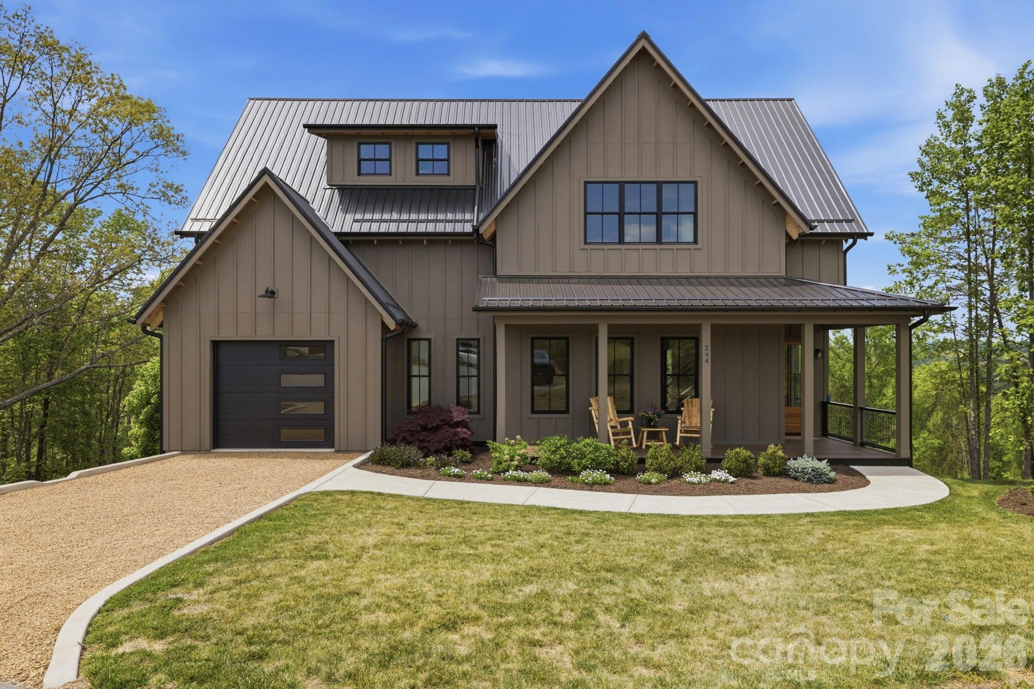 Positioned within the sought-after Olivette community, this modern farmhouse offers a refined blend of contemporary comfort, energy efficiency, and natural beauty. Westridge Farm Rd borders the community’s working organic farm, boasts a stunning community fire pit, and community garden space. Just 15 minutes from Asheville and Weaverville, this home & community strike the rare balance of privacy and convenience.

Built by Ward Enterprises, the home is filled with natural light and designed for effortless living. The open-concept floor plan features soaring cathedral ceilings and seamless indoor-outdoor flow, creating an ideal environment for both everyday living and entertaining. Offering 3 bedrooms and 3 full bathrooms, the home also includes generous additional flex space—perfect for a home office, den, or guest overflow.

The kitchen is thoughtfully appointed with a large island, walk-in pantry, double oven, gas range, pot filler, and ample storage. The fully finished basement adds even more versatility for guests, fitness, work, or recreation. Geothermal heating, advanced framing, spray foam insulation, and fiber optic connectivity further enhance the home’s comfort, efficiency, and modern convenience.

Outdoor living is equally compelling, with a covered front porch, vaulted & covered oversized back porch, & multiple balconies designed to capture stunning western sunsets and long-range Blue Ridge Mountain views. Backing directly to a 16-acre conservation area, the property offers an exceptional sense of privacy and connection to the surrounding landscape.

Olivette is a 411-acre riverfront community centered around a fully operational four-season organic farm, offering a lifestyle unlike any other in the region. Residents enjoy access to walking and hiking trails, orchards, community gardens, pickleball court, a private river island with pavilion and fireplace, a fire circle amphitheater, suspended bridge, labyrinth, dog park, playground, and riverfront park. With direct access to these amenities and a setting that feels both peaceful and inspiring, this home offers more than beautiful construction—it offers a truly distinctive way of living.