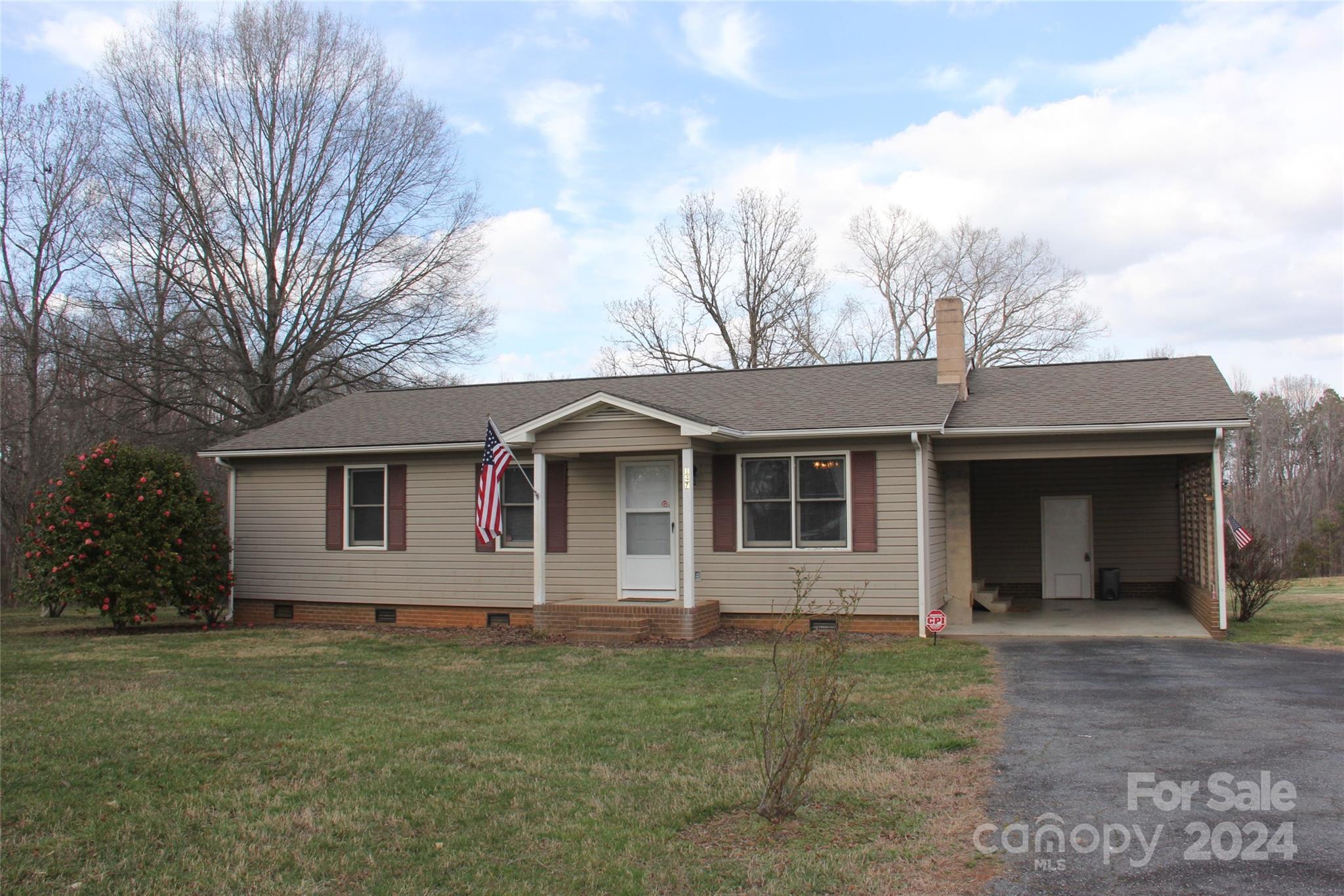 Great Mooresville location! Ranch style home with 7+/- acres, currently with Rural Agriculture (RA) zoning barely outside of city limits. Rear property line backs up to Gabriel Estates Subdivision. Just off NC Hwy 115, Statesville Hwy. Convenient to all Mooresville and Lake Norman amenities. Located at the end of a dead end street. Primary bedroom with ensuite. Open floorplan. Large deck for entertaining. Chair rail and wainscoting in dining area and hallway. Carpet in bedrooms. WPC Click Luxury Vinyl flooring used in kitchen, dining, living room and hall with extra  for any future installation needs. Revotec Engineered Flooring in bathrooms with extra for any future installation needs. 3 exterior outbuildings all with power. This one is a perfect home with acreage and privacy OR possibly potential development/investment project.