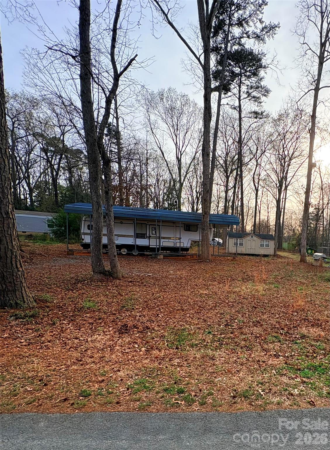 Have a slice of heaven at High Rock Lake! Available now for you to enjoy .30 of an acre one street away from the water in Summer Place subdivision, you'll feel as though you are far away from the city. 
 This highly sought after area has both full-time, year-round residents and vacationers. Remaining on the land is a camper with all your amenities. It is an older model, but may suffice  for weekend getaways. It's the buyer's choice to keep or tow away. In the past, the Seller has brought bottled water or gotten some from the neighbors. There is no Well and no Septic so you will need to do your own research into this matter. Very friendly Neighborhood with a casual HOA just to keep everyone tidy! Since you are so close to the boat ramp and the water is almost across the street, you may want to look into a golf cart to scoot around the area.