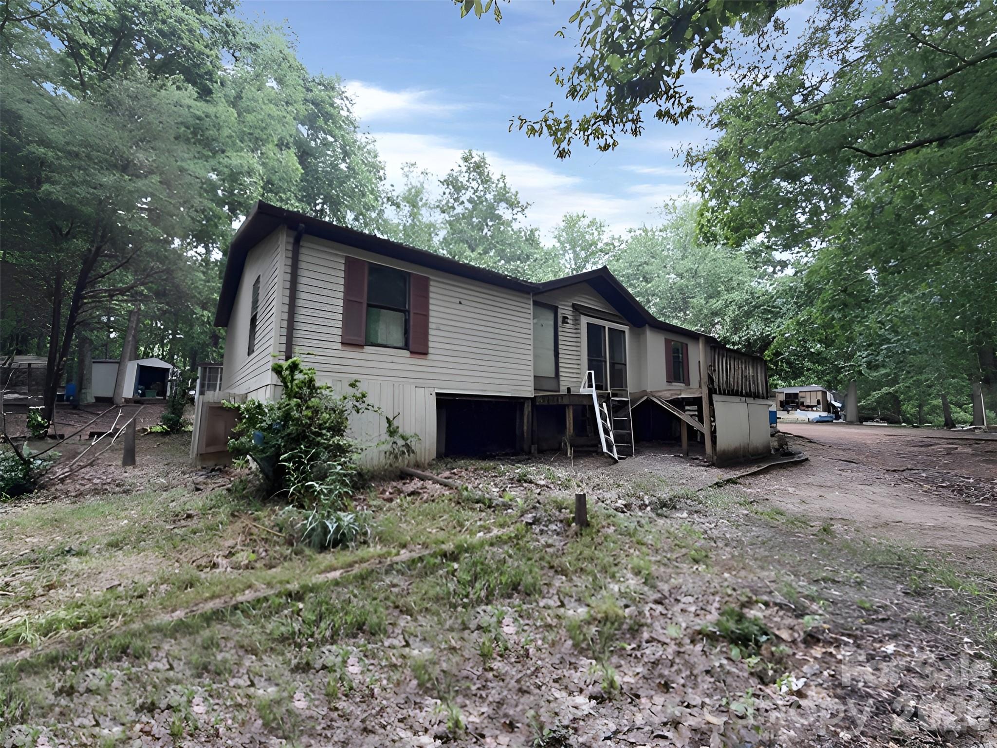 Investor Special on 10.7 Acres in Kings Mountain!
Unlock the potential of this rare 10.7-acre property offering privacy, space, and endless possibilities. Nestled among mature trees in a peaceful rural setting, this property features a manufactured home ready for renovation, rental income, or replacement with your dream home. The spacious homesite includes a large deck, wooded surroundings, and ample room for additional structures, recreational use, gardening, or future expansion.
Located just minutes from downtown Kings Mountain, you'll enjoy convenient access to shopping, dining, schools, and everyday necessities while maintaining the serenity of country living. Outdoor enthusiasts will appreciate the proximity to Crowders Mountain State Park, Kings Mountain Gateway Trail, and Kings Mountain National Military Park. Commuters benefit from easy access to US-74, I-85, Gastonia, Shelby, and the greater Charlotte metro area.
Whether you're an investor seeking acreage, a flipper looking for your next project, or a buyer dreaming of a private homestead, this unique property offers an exceptional opportunity at an attractive value. Bring your vision and make this 10.7-acre retreat your own!