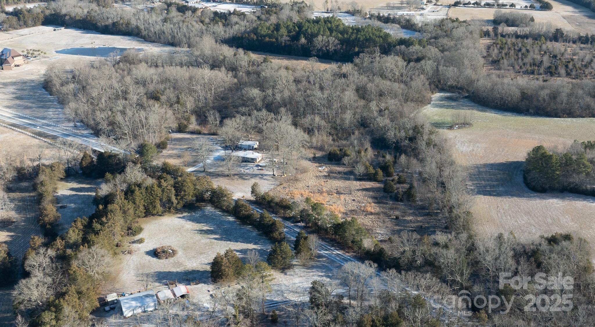 Nestled in a peaceful, private setting just 6 miles from shopping and downtown Rock Hill, this beautiful 10.65-acre property offers the perfect opportunity to build your dream home. With a serene backdrop provided by Stony Fork Stream, this partly cleared parcel is surrounded by mature trees, ensuring both privacy and a natural retreat feel. A
concrete pad for parking is already in place and the well & septic are installed and currently functioning, saving time and money. The existing manufactured home & 2 outbuildings will convey at no value—perfect for storage or temporary use while building your new home. Selling "as is" with no repairs to be done and no showings in the manufactured home until contract accepted.