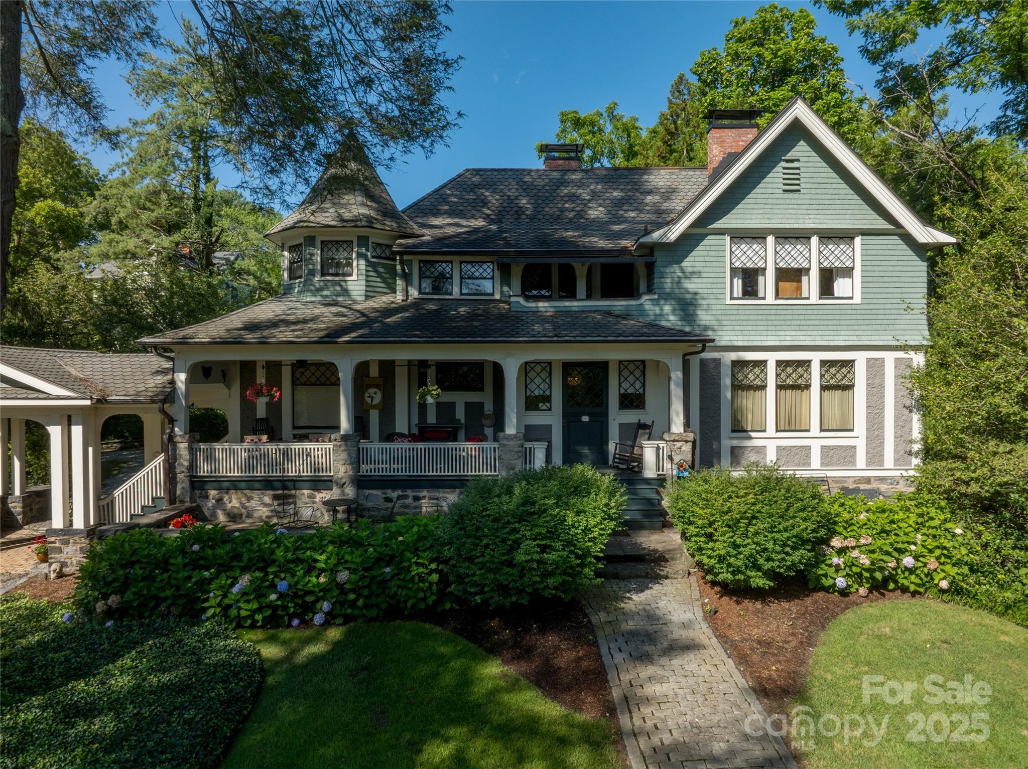 Asheville's most sought after architectural pedigree can be found here! Designed by the reknowned Richard Sharp Smith in 1899, this unique property boasts pebbledash walls, a corner turret, original diamond-paned windows, and a gracious front porch for watching the world go by. Charming cottage (added later) has an apartment waiting for guests and two additional suites. Fireplaces with original mantels, soaring ceilings, intricate woodwork and moldings infuse the home with timeless character. Set on meticulously maintained grounds, the property also features two tranquil ponds, creating a serene outdoor retreat that complements the historic charm of the residence.Timeless craftsmanship meets quiet elegance in this truly unique home.
