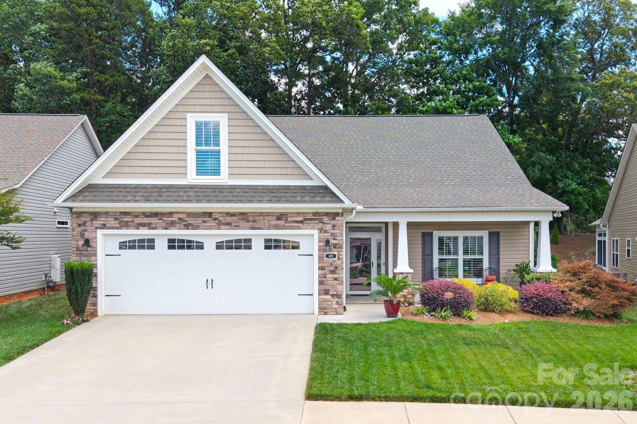 Beautifully designed 3-bedroom, 2-bath home with 2,515 square feet in the sought-after 55+ Gables community. This open-concept floor plan features a spacious living area with a coffered ceiling and stone gas fireplace, flowing seamlessly into the chef’s kitchen with granite countertops, a large island, stainless steel appliances, gas range, walk-in pantry, and generous dining space. Relax year-round in the sunroom or unwind on the screened porch overlooking the private, professionally landscaped backyard. The spacious primary suite offers a walk-in closet, dual vanity, and elegant tiled shower. Enjoy low-maintenance living with HOA lawn care plus outstanding amenities including a clubhouse, fitness room, library, game room, and more—all conveniently located near shopping, dining, and I-85.