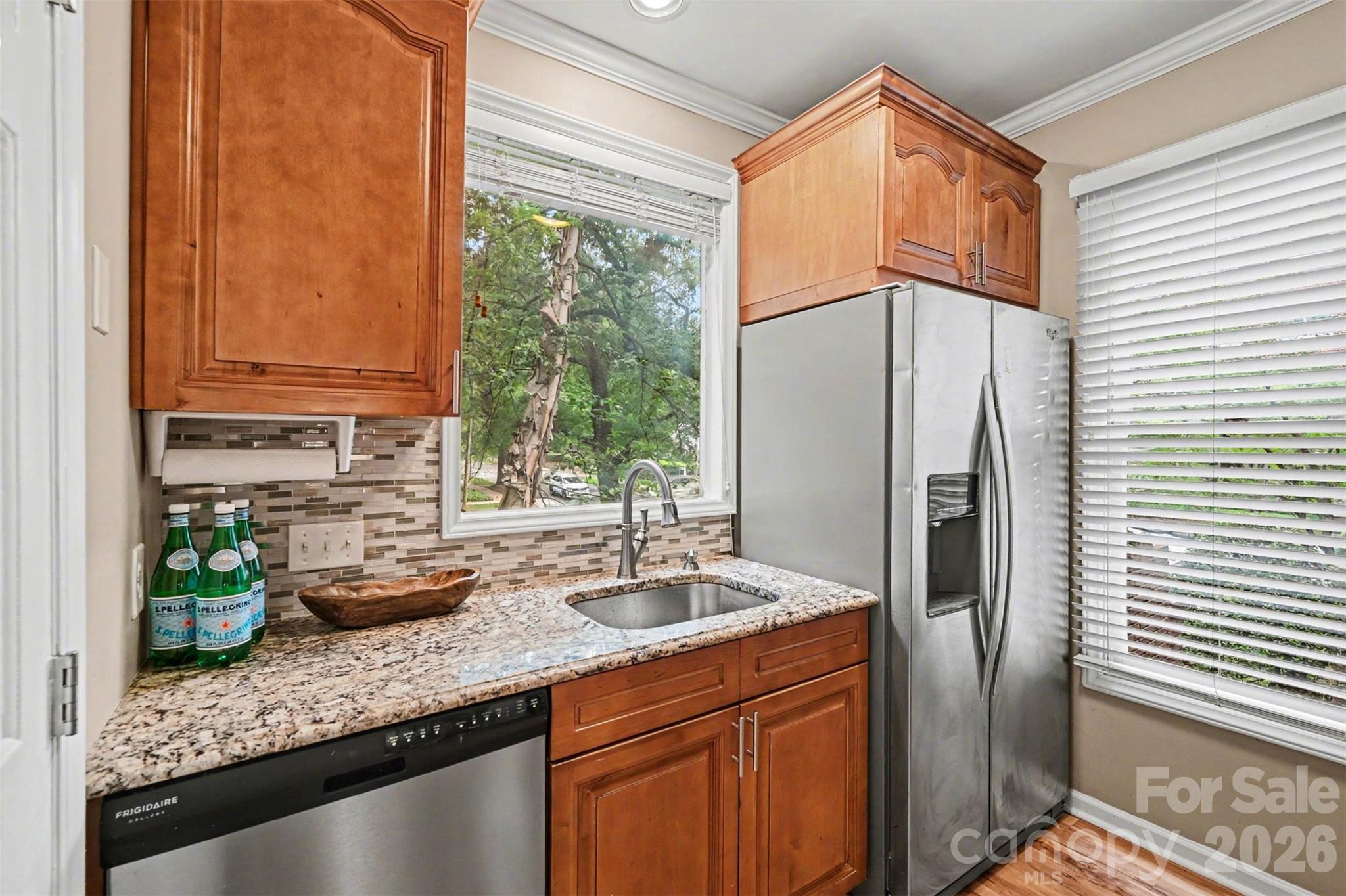 Perfectly positioned in the heart of Dilworth, this beautifully maintained 2-bedroom, 1.5-bath condo offers the ideal combination of charm, convenience, and low-maintenance living. Located in the sought-after Latta Square community, residents enjoy easy access to the Little Sugar Creek Greenway, popular restaurants, boutique shopping, coffee shops, nightlife, and all the energy of nearby South End and Uptown Charlotte.

Step inside to find a bright and inviting interior with an easy-flow floor plan designed for comfortable everyday living. The welcoming living area is anchored by a cozy fireplace and offers direct access to a private covered balcony—perfect for relaxing outdoors or enjoying peaceful neighborhood views. The kitchen features granite countertops, abundant cabinetry, and functional prep space ideal for both cooking and entertaining.

Upstairs, the spacious primary bedroom includes a private ensuite bath and ample closet storage, while the secondary bedroom provides excellent versatility for guests, a roommate setup, or a dedicated work-from-home space.

Latta Square residents enjoy community amenities including a pool, plus HOA coverage for water, trash service, lawn care, exterior maintenance, and more. Whether you're searching for a primary residence, investment opportunity, or a lock-and-leave lifestyle in one of Charlotte’s most desirable neighborhoods, this Dilworth condo is a rare opportunity to enjoy urban living with neighborhood charm.