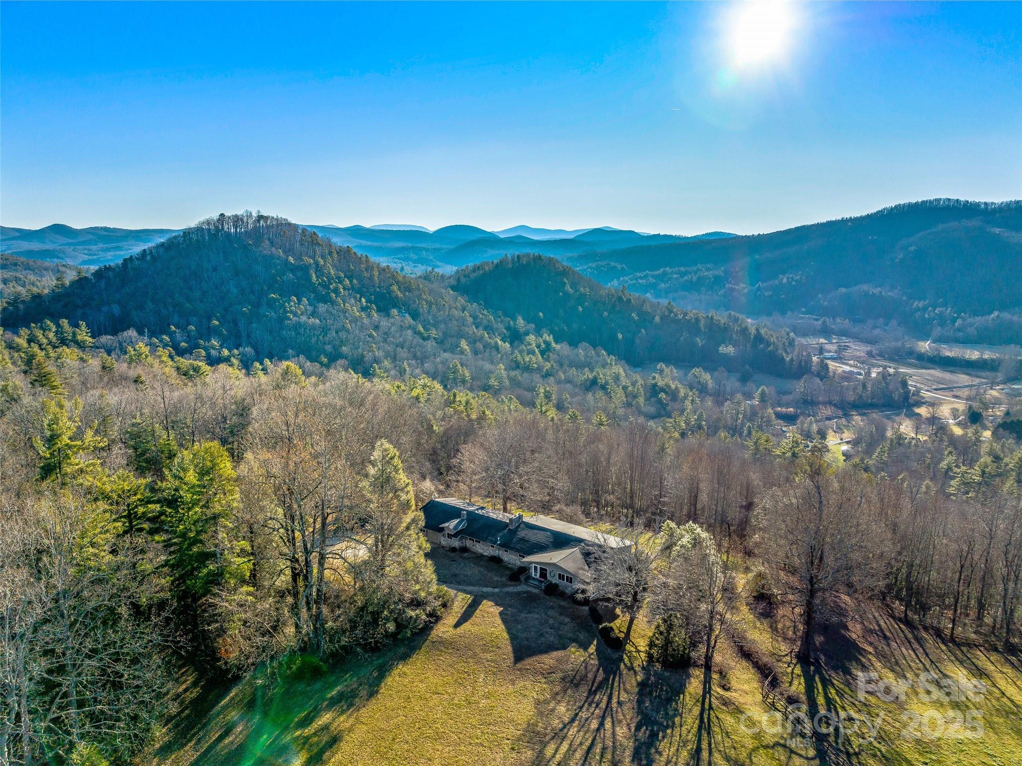 An unparalleled 190-acre, once-in-a-lifetime offering to own a piece of secluded paradise. This untouched landscape offers stunning mountain views, cascading waterfalls, and easy access to historic Hendersonville (12 miles) and Greenville (30 miles). Three magnificent waterfalls, ideal for a nature-loving family retreat. Numerous build sites, plus a genuine mid-century modern home. No HOA restrictions, enabling the main home to function as a rental for corporate or family retreats. Nestled amid Camps Arrowhead and Glen Arden, this gem boasts expansive windows framing the Blue Ridge and Green River Valley. Wormy Chestnut paneling, sassafras paneling, oak flooring sourced from the estate and walnut flooring, brick and other adornments rescued from homes in the Greenville Water Shed. Seize this rare opportunity to embrace a secluded luxury location. Inquire about options for Seller financing. Shared well with Camp Glen Arden. Current private well permit on file. Covered pavilion near pond.