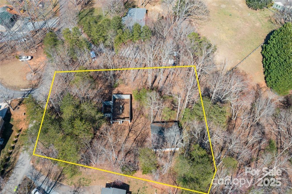 Presenting an exceptional opportunity just moments from downtown Columbus, NC. This unfinished residential building offers the perfect chance to create your dream home. The structure features a 12x16 split rock stone façade, and the construction has been started on a spacious design. The property includes an installed 3-bedroom septic system, city water service, and this neighborhood has access to natural gas. Additionally, there is a large, unfinished two-car garage, offering ample storage or potential workspace. The high-quality basement foundation provides a strong base for continued development, with electrical already on site. Originally designed by Blue Ridge Log Cabins (contact the listing agent for a copy of the blueprint), you can either complete this build as planned or reimagine the space to suit your personal vision. This is a rare opportunity to build a home with exceptional potential in a prime location!