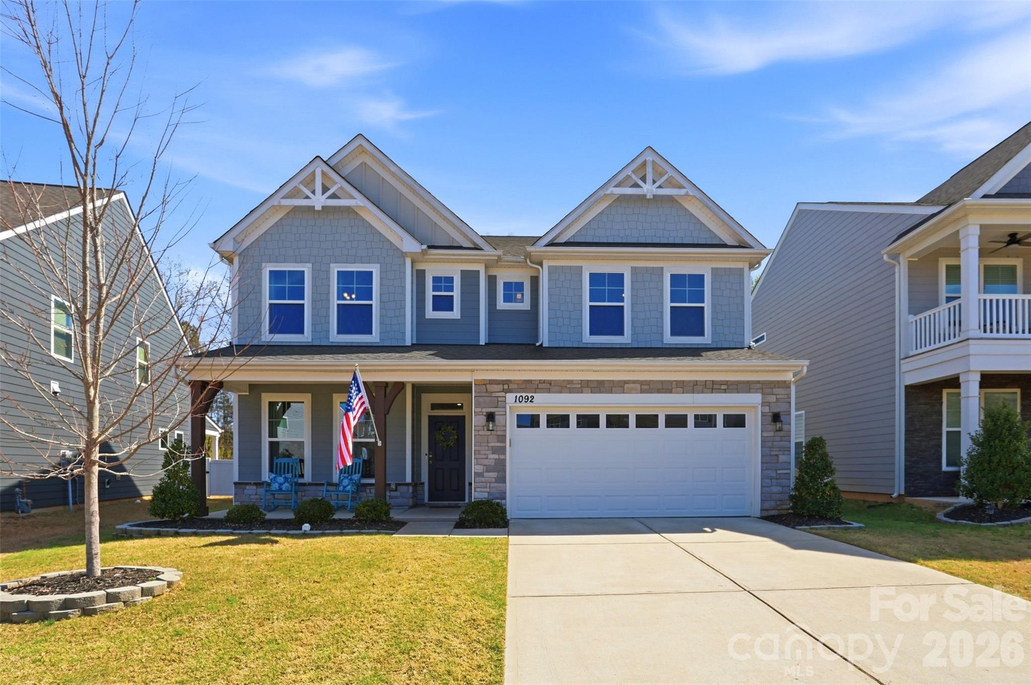 Steps away from this amenity rich neighborhood, this gorgeously maintained 5-bedroom, 3-bath home with 3,137 square feet of well-designed living space is your solution to a lifestyle change. The two-story home offers timeless curb appeal, thoughtful design, and inviting indoor-outdoor living. The charming exterior features attractive stone accents, multiple front-facing gables, a covered rocking-chair front porch, and a spacious finished two-car garage equipped with EV outlet and lawn equipment storage cove.  Inside, the home opens to a bright, elegant foyer accented by crown molding, wainscoting, and rich LVP flooring that flows throughout the main living areas. A private front office with French doors provides the perfect work-from-home space, while the formal dining room offers an ideal setting for gatherings and holidays.  The heart of the home is the open-concept kitchen and living area. The kitchen is beautifully appointed with custom white cabinetry, stainless steel appliances, a gas cooktop, wall oven and microwave, tile backsplash, pendant lighting, and a large center island with extra cabinets on the seating side. It opens seamlessly to the breakfast area and spacious great room, where a striking floor-to-ceiling stone fireplace creates a warm focal point.  Main level guest room with ensuite.  Flex space/mud room/drop zone conveniently off the garage.  Upstairs, 3 generous secondary bedrooms and a versatile loft provide flexible living space for guests, recreation, or media use. The oversized primary suite offers a relaxing retreat with abundant natural light, a large walk-in closet, and a spa-like bath featuring a soaking tub and separate tiled shower.  Laundry room w/sink conveniently located upstairs. Step outside to enjoy a fenced backyard complete with a covered patio, extended paver patio, natural gas to grill and fire pit area. Backing to a wooded setting, the outdoor space offers a private backdrop for entertaining and relaxing. Situated on a .13-acre lot in Walnut Creek, where residents enjoy sports fields, tennis courts, swimming pools, clubhouse with exercise room, pond, and walking trails.