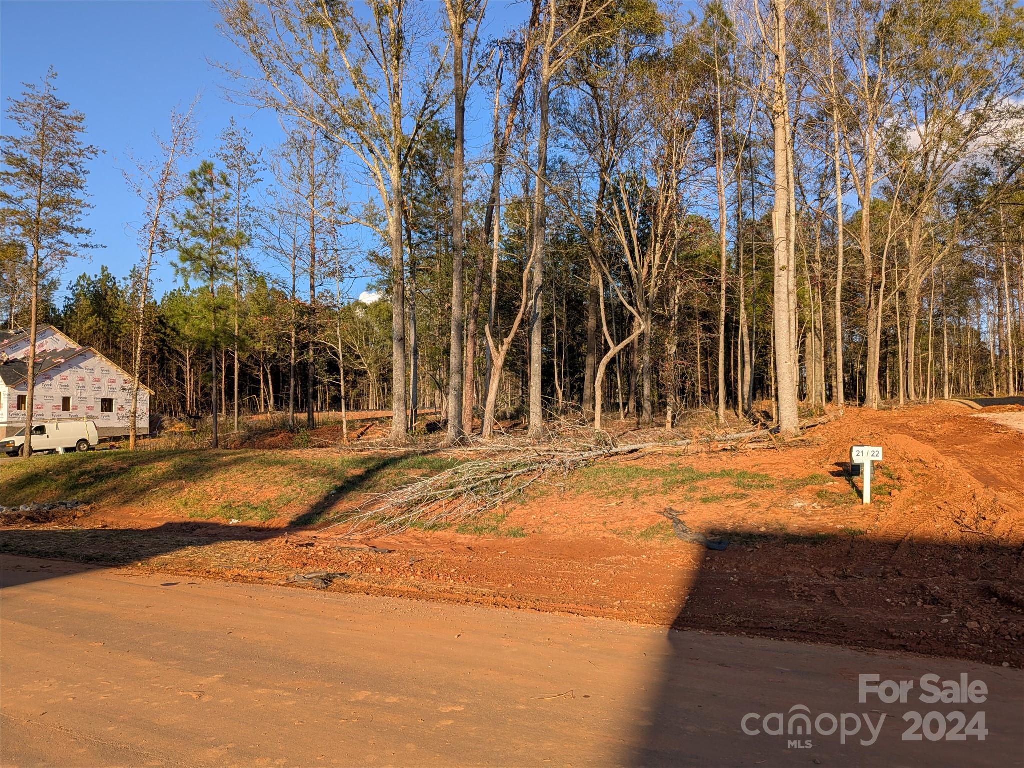 Beautifully wooded lot located on a corner lot of new neighborhood, Heartland Acres. Over one acre of land. Well and septic tank needed. Septic tank permit included. Come check out this residential lot today to build your future dream home on!