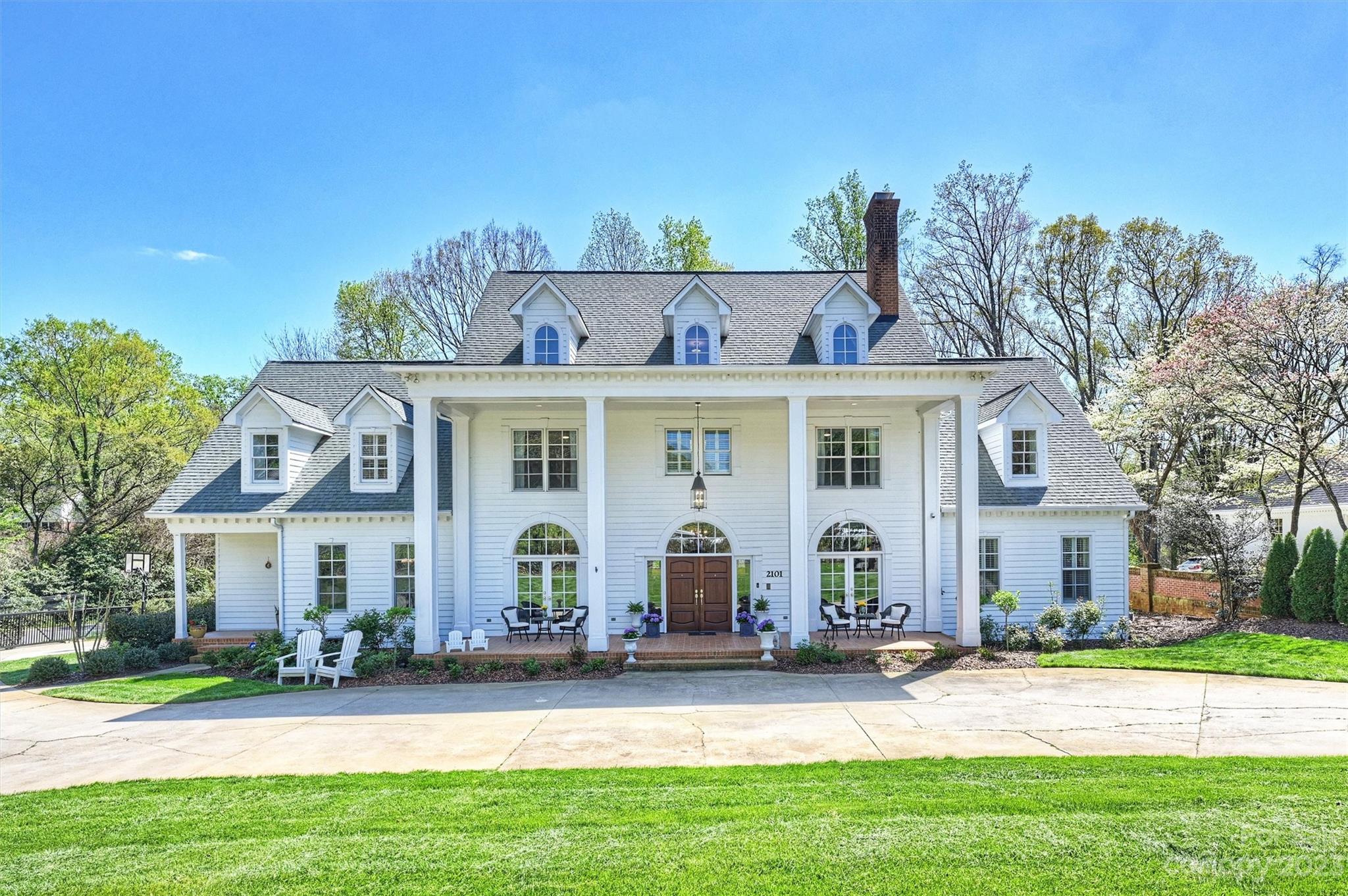 Wonderful Foxcroft home w/ "father of the bride" classic curb appeal & 1+ acre park like rear yard. Dramatic formal  & inviting informal spaces, multiple primary suite options & layout that affords tremendous versatility w/ the wow factor you expect. The lot is fully fenced and provides surprising privacy while being in the midst of all that Foxcroft has to offer. Living room w/ cathedral ceilings & soaring fireplace is the centerpiece of the home. Formals include elegant library w/ FP & dining room w/ custom trim. Kitchen w/ island seating, breakfast area, & inviting hearth room with FP. Main floor primary suite w fireplace & dual closets. Large bedrm suites on 2nd and 3rd floors, w/ second primary suite option. 3rd floor could be an au pair, MIL suite or home office. Another flex space w/ kitchenette off garage entrance.  Outdoor living includes expansive deck with 3 seating areas. The large front porch, 4 car garage, circular drive w/ electric gates round out this estate like home.