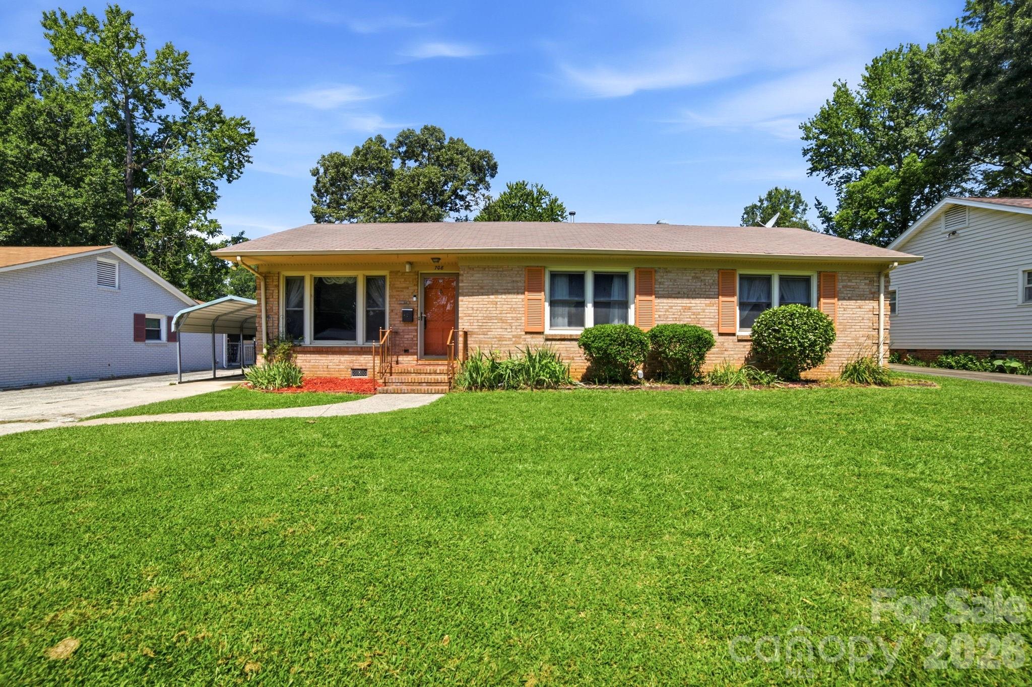 Welcome to this well-maintained 3-bedroom, 1.5-bath brick ranch nestled in the established Shannon Park neighborhood. Full of character and timeless appeal, this home offers beautiful hardwood floors throughout much of the living area and bedrooms, spacious formal living and dining room, and a large den perfect for entertaining, relaxing, or creating the ultimate bonus space. The kitchen features abundant cabinetry, a breakfast area, and an adjacent workspace, offering endless possibilities to update or personalize to your taste. The generous primary bedroom includes a convenient full bath, while two additional bedrooms provide plenty of space for family, guests, or a home office. Step outside to enjoy the expansive, level backyard with mature shade trees, a storage building, and plenty of room for gardening, pets, or outdoor gatherings. A covered carport adds everyday convenience. Located just minutes from Plaza Midwood, NoDa, and Uptown Charlotte, you'll enjoy quick access to shopping, dining, entertainment, parks, and major commuter routes while still enjoying the charm of an established neighborhood. Whether you're a first-time buyer, investor, or someone looking to update a solid brick home in a fantastic location, this property is full of opportunity. Don't miss your chance to make it your own! We have received multiple offers on this property.