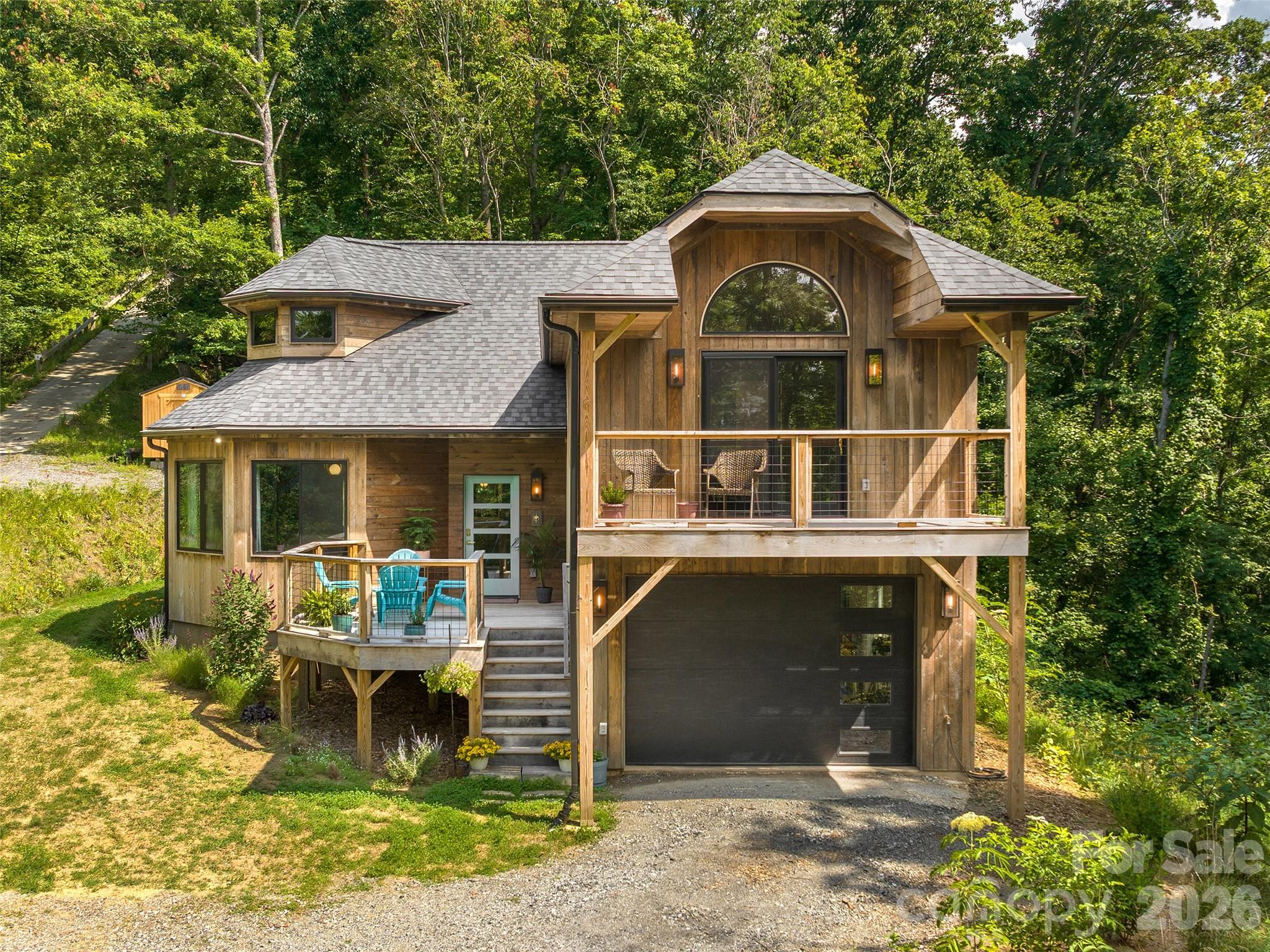 Welcome to your mountain sanctuary: a unique retreat on 1.57 acres within a pristine intentional community
just north of Weaverville. Green-built with white oak siding and gutter guards, this home features
hardwood floors, a vibrant kitchen with quartz countertops, striking backsplash, and high-end stainless
appliances. The flexible floor plan invites creativity. The dining room could easily become a second
bedroom on the same level as a luxurious full bath, while the primary suite boasts a tiled bath, private
deck, and peaceful mountain views. The uppermost floor offers a bright office with eave storage, and the
basement includes a garage and dedicated storage room. A spacious deck and hot tub beckon outdoor living
and stargazing from this quiet cul-de-sac with peek-a-boo mountain views. Mountain Meadows amenities
include a clubhouse with full kitchen, pavilion, community garden, and chickens and rabbits are welcome!
Regular events like Cornhole & Conversation Thursdays and Deck Crawls make this community truly special.
If you've been searching for a mindful, connected lifestyle, you've just found it.