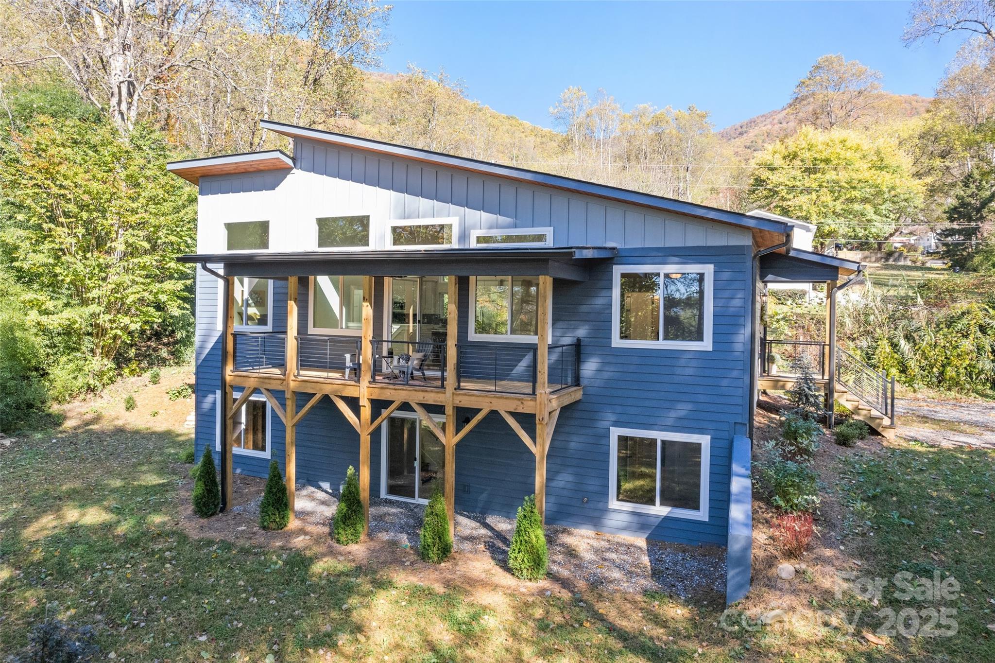 PRICE IMPROVEMENT! Discover this beautifully newly constructed 3BR/3BA home, ideally located in the sought-after Fisher Creek area. Enjoy privacy and convenience just minutes from Pinnacle Park, with easy access to Downtown Sylva, WCU, and the hospital. Inside, the open-concept layout is filled with natural light, large windows, quartz countertops, and a gas fireplace. Enjoy cozy evenings by the fire or peaceful mornings on the covered front porch, listening to the soothing sounds of Fisher Creek just across the road. Additional finished living space is perfect for a recreation room, home gym, or guest area, plus there's an unfinished room with endless potential—ideal for a workshop, studio, or extra storage. The yard features a woodland creek winding through a bamboo grove, and a wildflower/pollinator garden that blooms each spring on the south side of the driveway. A serene mountain retreat with modern comforts—don’t miss it!