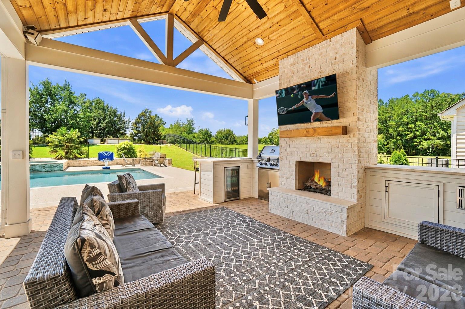 Welcome to a true backyard paradise, where luxury, recreation, and resort-style living come together in an entertainer's dream setting. This exceptional 5-bedroom, 4-bath home is defined by an outdoor oasis designed for both entertaining and everyday enjoyment. The backyard showcases a custom pool with waterfall, hot tub, covered outdoor living area with gas fireplace and outdoor kitchen, fire pit, basketball court, putting green, expansive patio spaces, and plenty of open lawn, creating the ultimate setting for gathering with family and friends.

This thoughtfully designed floor plan, drenched in natural light, offers an open-concept layout with a rare secondary primary suite on the main level. The gourmet kitchen features granite countertops, abundant cabinetry, stainless steel appliances, a pantry, and a breakfast area that flows seamlessly into the spacious great room with a gas fireplace. The main level also includes a formal dining room and a private office with stylish French doors.

The second floor features the primary suite with a sitting area, three additional generously sized bedrooms with ample closet space, and two additional full bathrooms.

Waterford is a vibrant, social community with year-round neighborhood events and activities for all ages. Neighborhood amenities include walking trails and a community pool. Conveniently located near Downtown Kannapolis, Davidson, and Huntersville, this home offers a rare combination of luxury, privacy, recreation, and convenience.