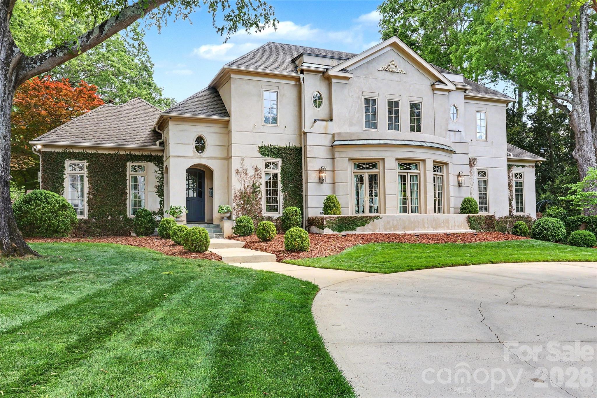 Nestled along the esteemed Queens Road East, this beautiful residence offers a refined and inviting home in one of Charlotte’s most distinguished neighborhoods, Myers Park. This property enjoys a serene, park-like setting adjacent to Myers Park Country Club, framed by mature trees, thoughtfully landscaped gardens, and a spacious bluestone patio ideal for dining, entertaining, or quiet enjoyment.
The interior welcomes you with timeless sophistication and contemporary updates. Bluestone tile flows gracefully throughout the main level, creating a seamless foundation for the beautifully renovated kitchen, living room, and dining areas. The kitchen serves as a true centerpiece, appointed with premium Wolf and Thermador appliances that cater to the discerning home chef. An open layout makes these spaces both elegant and highly functional for everyday living and gracious gatherings. Adding to the convenience, the primary bedroom is thoughtfully situated on the main floor.
Additional comforts include a whole-house Generac generator for uninterrupted power and a comprehensive security system for peace of mind.
Conveniently located, the home offers effortless access to Uptown Charlotte, SouthPark, Park Road Shopping Center, Freedom Park, and the renowned Greenway trails—placing the best of Charlotte’s dining, shopping, recreation, and cultural amenities just moments away.
Sophisticated, approachable, and impeccably maintained, 2301 Queens Road East is a rare opportunity to enjoy refined living in a coveted Myers Park location.