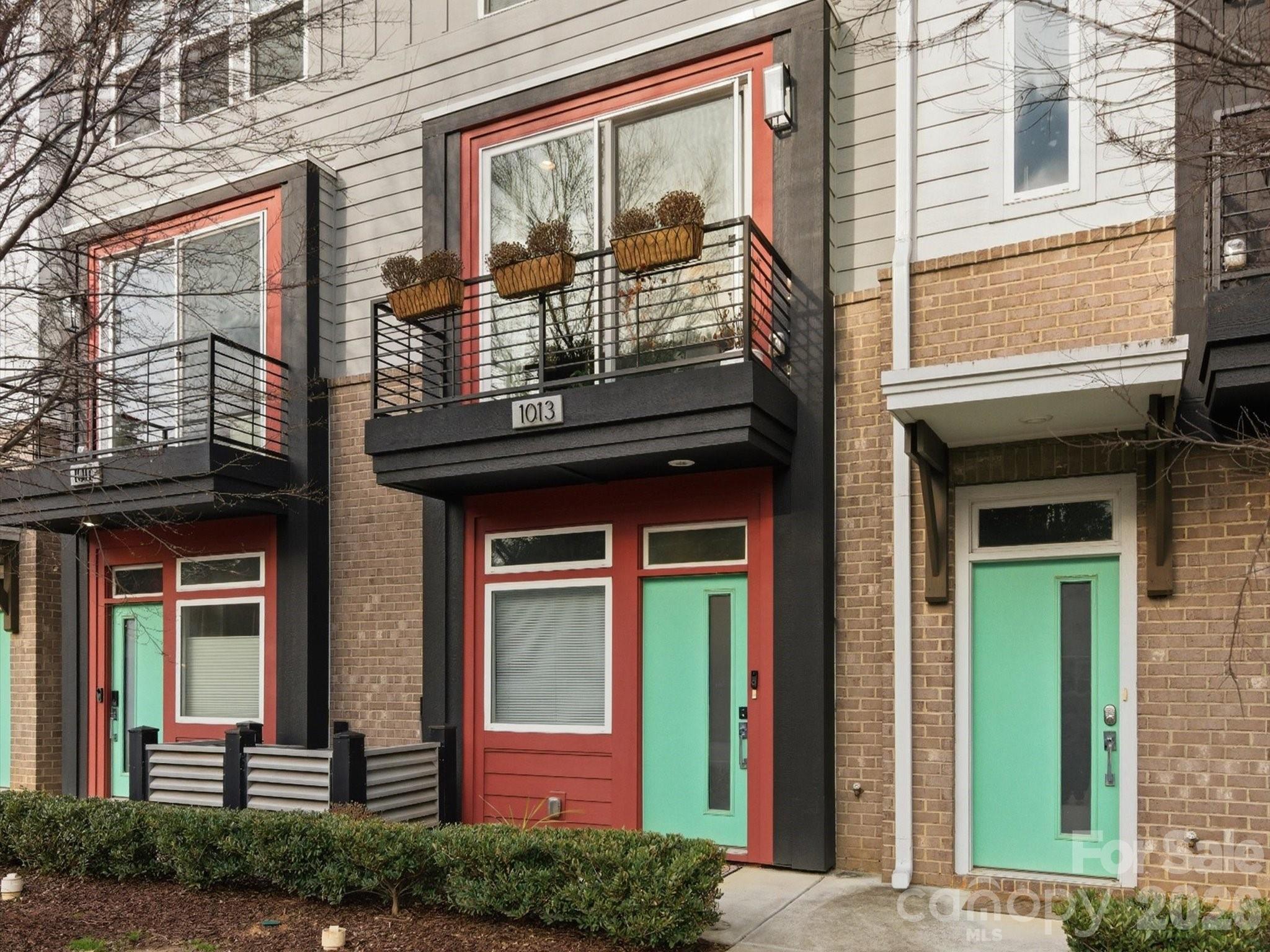 Life in NoDa has a rhythm. Morning coffee on the walk to the light rail. Dinner with friends on the strip. Evenings spent on a private rooftop above the energy of the city. At 1013 E 36th Street, that lifestyle is right outside your door.

Located in Landings at NoDa, this thoughtfully designed townhome blends modern architecture, natural light, and low-maintenance living in one of Charlotte's most vibrant neighborhoods. From the moment you step inside, the dramatic open stairwell and soaring vertical volume create a sense of openness that sets the home apart. Expansive front-facing windows fill the living spaces with natural light while offering wide sightlines down 36th Street, creating a bright, urban atmosphere throughout.

The main living level is designed for both everyday living and entertaining. Quartz countertops, tile backsplash, and clean modern finishes complement an open layout that flows effortlessly between the kitchen, dining, and living areas.

Upstairs, the private rooftop terrace becomes a true extension of the home. Positioned away from direct street noise and framed by privacy walls, it offers a quiet retreat for morning coffee, relaxing after work, or hosting friends before a night out in NoDa.

A rare two-car garage provides convenience and security, while the street-facing orientation gives the home a more open feel than many interior-facing units. HOA-maintained exterior spaces allow for true lock-and-leave simplicity without sacrificing the walkability and character that make NoDa so desirable.

Just a 10-minute walk to both the NoDa entertainment district and the 36th Street LYNX station, this home delivers the walkable urban lifestyle buyers love while offering the comfort and convenience of newer construction. For those who appreciate the character of historic neighborhoods but prefer modern design, natural light, and minimal upkeep, 1013 E 36th Street offers a unique opportunity to experience NoDa in a different way.

Modern. Walkable. Effortless. Welcome home.