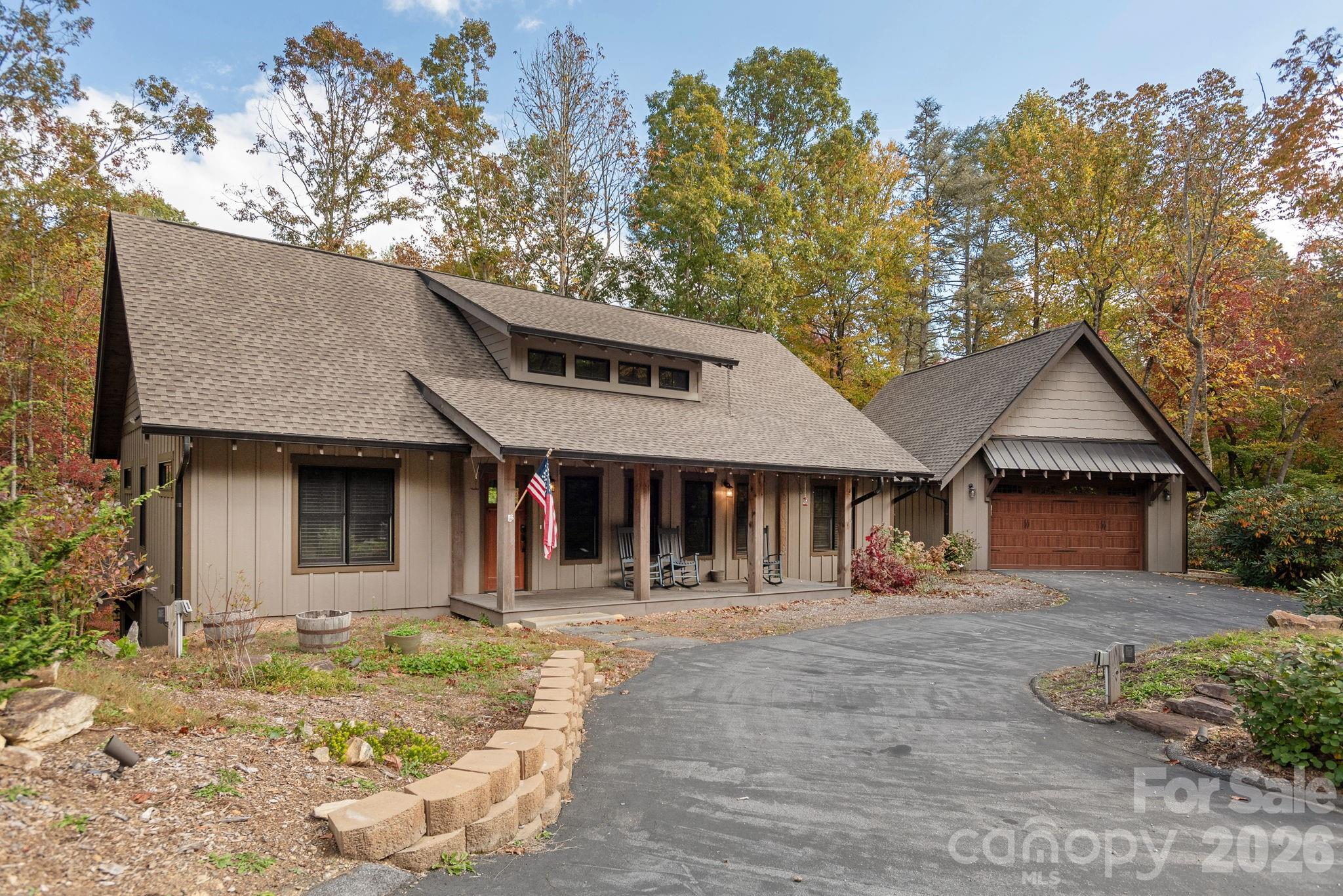 This custom-built home in Lobdell Woods offers the best of both worlds, peaceful forest living with quick access to downtown Brevard. Only 2.7 miles from Pisgah National Forest entrance and 6 miles from downtown Brevard. Just a short drive from vibrant downtown shops, restaurants, and events. The home features vaulted tongue-and-groove ceilings, granite countertops, hardwood and tile floors, a central vacuum, and a split-bedroom plan with a fun built-in bunk room behind the rock fireplace. Step onto the spacious vaulted back porch to enjoy views of the woods and creek, with a 2-car garage on the main level and a workshop below.
