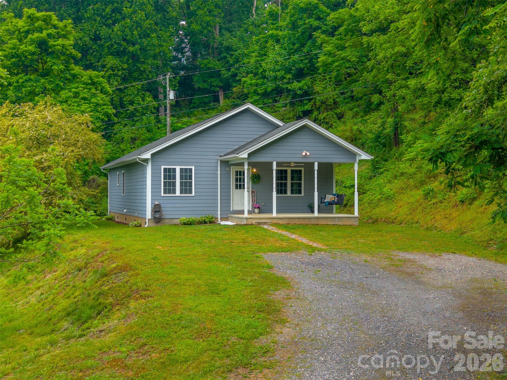 Enjoy the perfect blend of modern comfort and mountain convenience in this charming 3-bedroom, 2-bathroom home built in 2016. Offering bright, single-level living on a 0.5-acre lot within the city limits, this property combines everyday ease with end-of-road privacy and a peaceful mountain setting and views. Enjoy the benefits of city water, city sewer, and trash pickup. Inside, the thoughtfully designed split-bedroom floor plan offers privacy and functionality. The spacious primary suite is tucked just off the kitchen and features a walk-in closet and private ensuite bath. The open-concept kitchen and dining area flow seamlessly together, creating an inviting space for everyday living or entertaining, while the oversized living room offers plenty of room to relax and gather. Step outside and imagine transforming the outdoor area into your own private oasis — perfect for cozy evenings under the pergola, entertaining friends, or simply enjoying the mountain air. Located just 5 minutes from downtown Sylva, you’ll have quick access to local shops, breweries, restaurants, and coffee spots, while WCU is only minutes away as well. This one is ready for you!!!