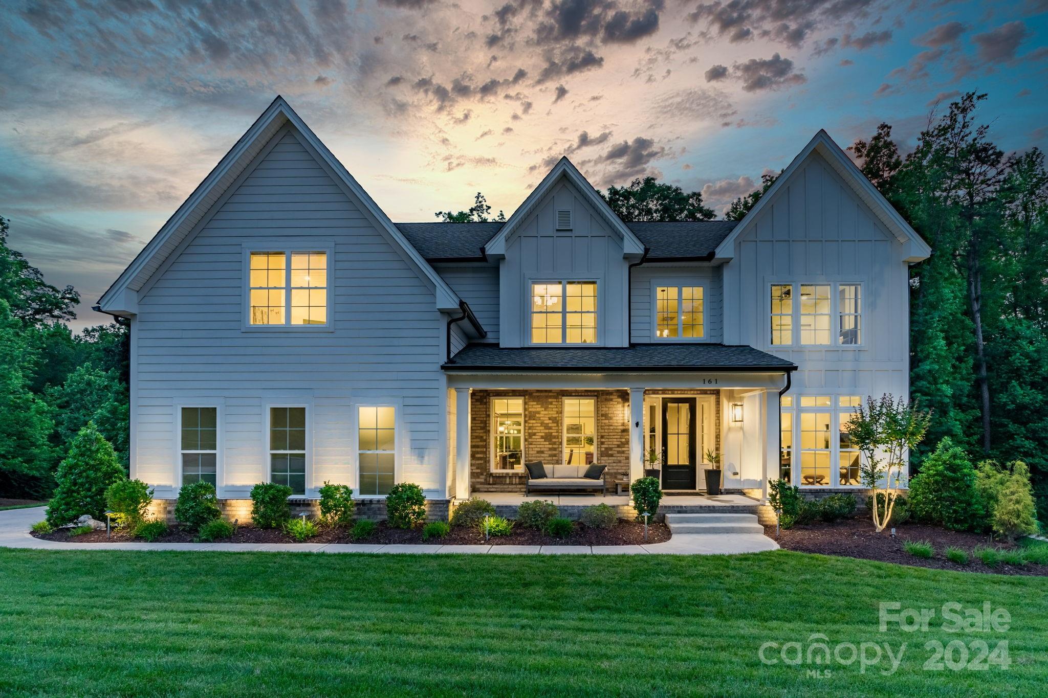 This meticulously maintained MODEL home is move-in ready in the exclusive community of The Manors at Lake Ridge of Fort Mill. This stunning home boasts five bedrooms, a bonus room, four full baths with a bedroom and full bath on the main floor.  Crown molding with wood beams in the great room provide noticeable details. The open-floor plan has white oak wide plank flooring to add comfort and appeal.  The gourmet kitchen allows for abundant storage space in the oversized island, cabinets, soft close drawers, and desirable quartz countertops.  A walk-in pantry, mudroom, and utility closet allow for expansive storage space. With interior and exterior access to a huge basement, the storage space continues! The private backyard includes a screened-in porch, firepit, and scenic trees. The second floor primary bedroom ensuite shows off two oversized walk-in closets and a large garden tub. This smart home has lights, a speaker system, security and so much more through the Control 4 System.