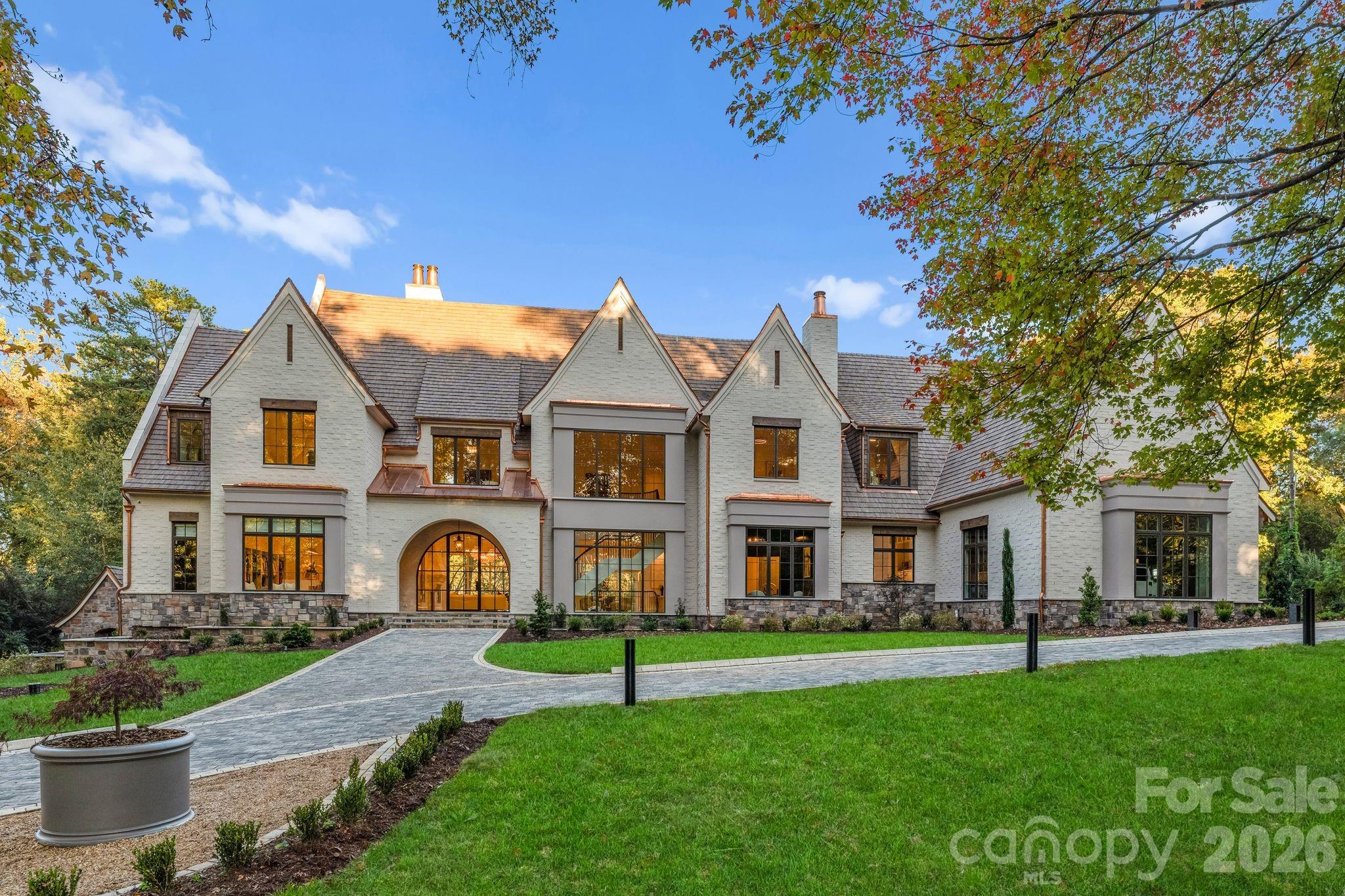Welcome to 433 Highland Forest Drive—an extraordinary estate set on approximately 3 acres of beautifully landscaped grounds with mature trees, offering over 15,000 square feet of meticulously designed living space. This one-of-a-kind residence seamlessly blends grand scale with refined elegance, delivering an unparalleled lifestyle of comfort, entertainment, and wellness.

Upon entry, soaring 12-foot ceilings on both the main and lower levels, striking architectural details, and expansive living areas create a dramatic first impression. Designed for both everyday living and large-scale entertaining, the home showcases exceptional craftsmanship throughout.

The fully finished lower level is an entertainer’s dream, complete with a private 12-seat theater, indoor bowling alley, arcade, billiards area, and golf simulator. A stunning bar with backlit pink onyx serves as the centerpiece of this space.

The main level includes a separate recreation room for more casual gatherings, featuring a Galley Workstation and True Residential drink refrigerator and a 84" fireplace.

Outdoor living rivals a private resort, showcasing an infinity-edge pool, hot tub, and full-size basketball court. Two outdoor kitchen areas are equipped with dual grills, a pizza oven, and a flat-top grill—ideal for elevated entertaining. Additional features include a fenced dog run, invisible fence, and built-in holiday lighting.

A dedicated wellness wing offers a true spa experience with heated floors, massage room, steam room, dry sauna, indoor pool, and a fully equipped gym with cork flooring.

The gourmet kitchen is anchored by a La Cornue Château 60" range and features custom white oak cabinetry, premium integrated appliances, and a Galley Workstation. A fully equipped Scullery includes a True Residential refrigerator, while a dedicated coffee bar features a built-in Miele coffee machine.

The primary suite provides a private retreat with heated floors, spa-like finishes, and expansive dual closets. A separate guest house with one bedroom and one-and-a-half baths offers comfortable, private accommodations.

With unmatched scale, world-class amenities, and exceptional attention to detail, this estate stands among Charlotte’s most distinctive luxury properties.