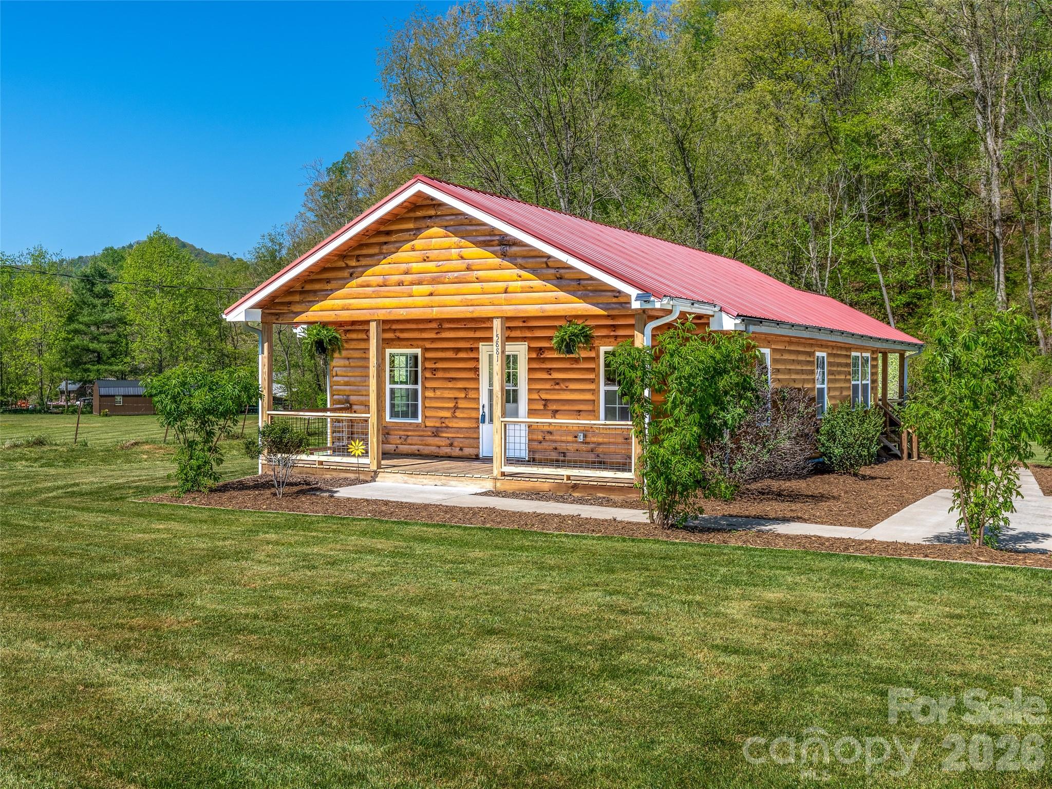 Welcome to this creekfront cabin with built-in income potential. Originally built in the 1930s, the main cabin was extensively remodeled down to the studs in 2021 with new walls, ceilings, roof, electrical, appliances, and more. The main home offers a comfortable floor plan, generous outdoor living space, a covered front porch, covered back porch, and creekside patio. Main home previously rented for $1,900/month.

Property also includes a 1-bedroom/1-bath additional dwelling unit currently rented for $900/month, featuring washer and dryer hookups, plus a mobile home lot rented for $400/month. Mobile home is tenant-owned and does not convey. Each unit has separate utilities and septic; septic systems were last pumped in 2025.

Conveniently located with easy access to I-26, downtown Mars Hill, Hatley Pointe, Tennessee, Weaverville, and Asheville. No known Helene damage. Parcel is partially located in a flood zone.