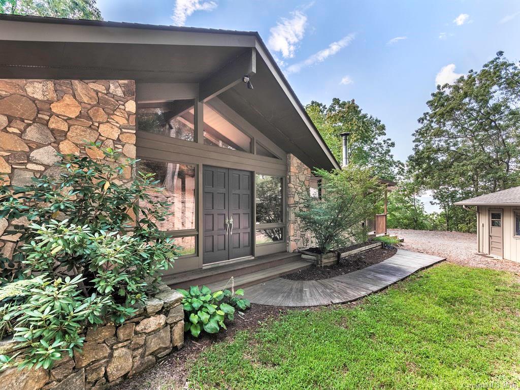 Mid-century custom home w/massive windows, completely surrounded by nature.  Beautiful, long-range views of town and the surrounding mountains while relaxing in front of a fire, enjoying breakfast or unwinding after a long day.  This home offers outdoor living, storage, a spacious workshop.  Convenient seclusion.  Lower level kitchen & living area.  No septic records found.