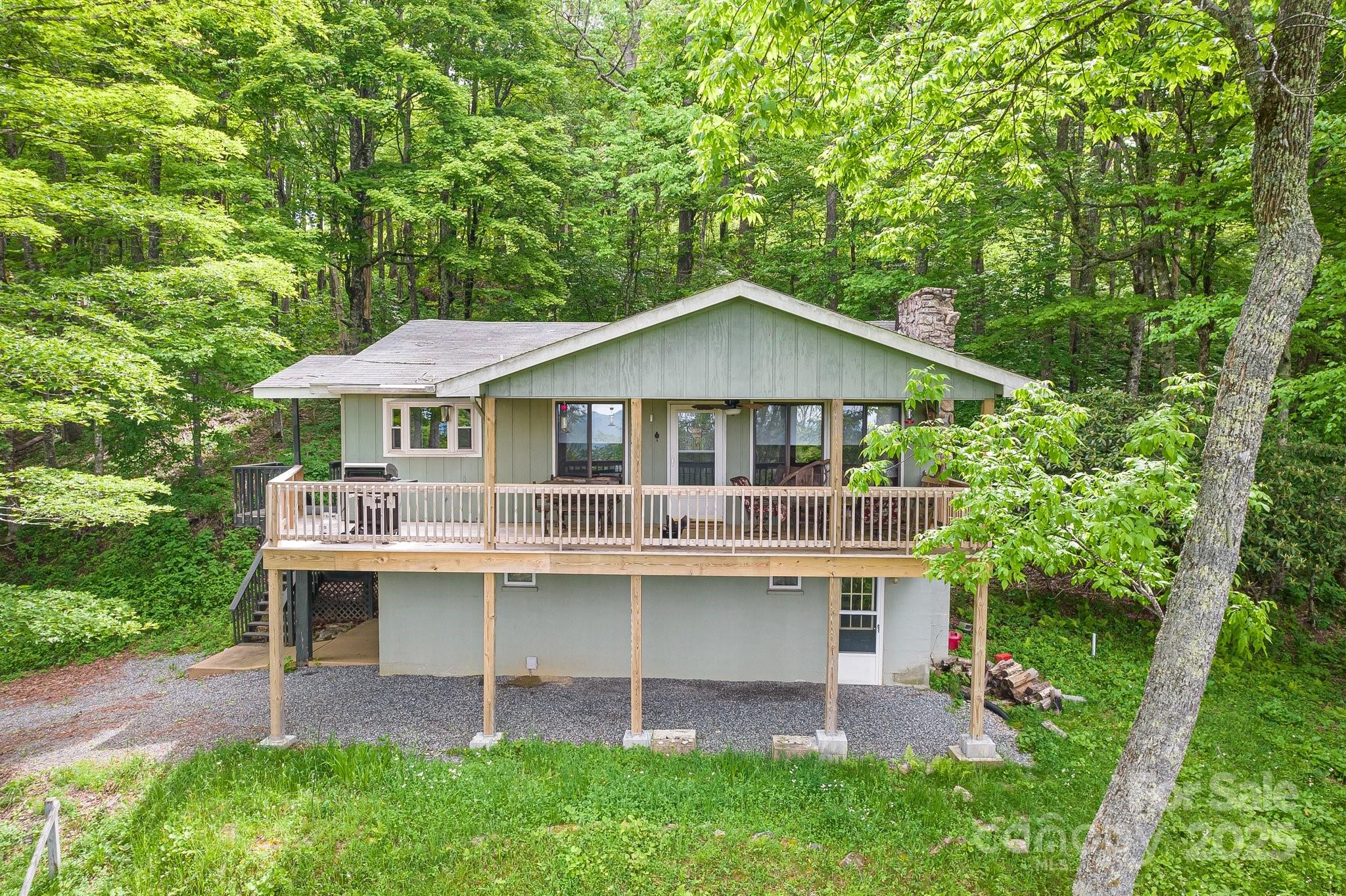 Within the picturesque mountains of Western North Carolina, Discover your charming retreat in the Wolf Laurel Community! This Home offers the perfect blend of location, comfort, and charm, featuring 2 bedrooms, 3 bathrooms, and a versatile lower-level bonus room currently used as an additional sleeping area. An open-concept layout creates a welcoming atmosphere, featuring both a living room and rec room for maximum flexibility. The kitchen is fully equipped with all appliances, granite countertops, and ample cabinet space.Embrace indoor-outdoor living on the large covered deck, which offers some long-range mountain views all year round. 

Offered fully furnished, this active vacation rental presents a turnkey investment opportunity near Wolf Laurel's popular amenities, including golf, skiing, and hiking trails. Just moments away is Hatley Pointe, the area's newest ski and mountain bike resort. All this is conveniently located only 45 minutes from the vibrant restaurants, art, and music of Asheville, and less than an hour from the airport. Don't miss out on this incredible opportunity, Showing appointment availability is subject to guest reservations.